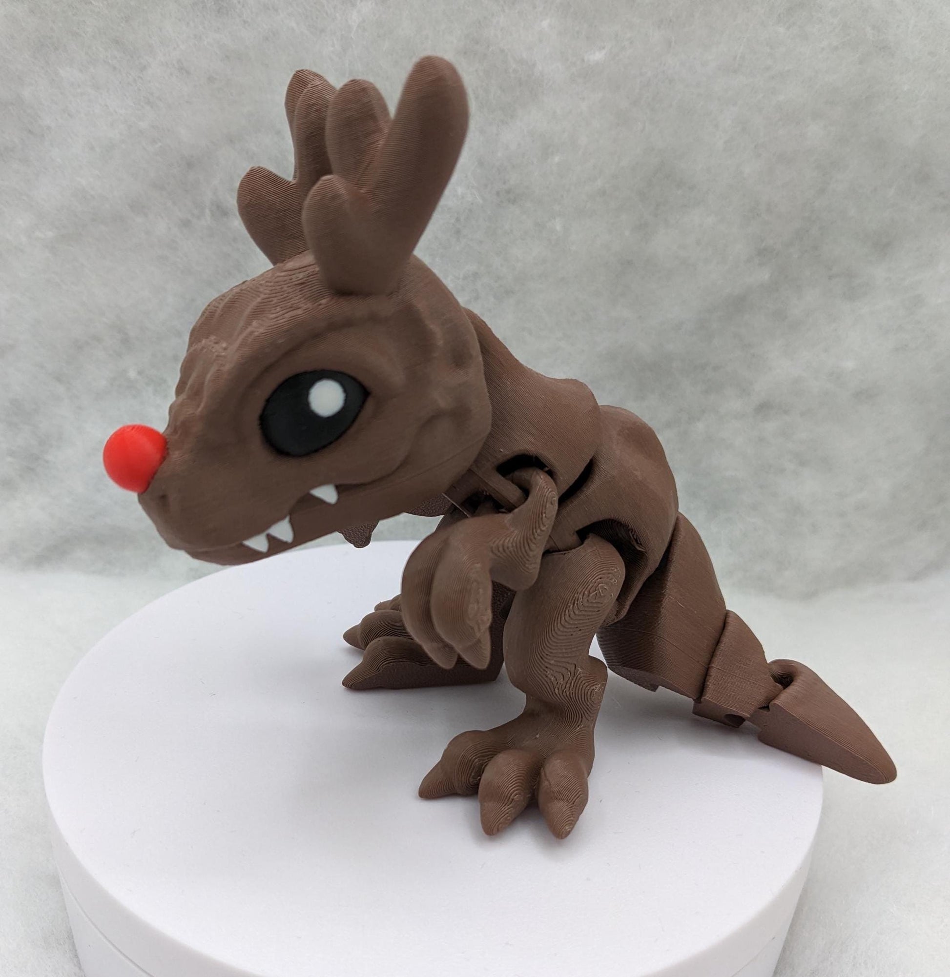 Our Christmas T-Rex combines the charm of Christmas with the fun of dinosaurs. An interactive toy for kids & adults alike,  articulated joints for posing & fidgeting, T-Rex is perfect as a stocking stuffer, desk toy, or playful holiday decoration.