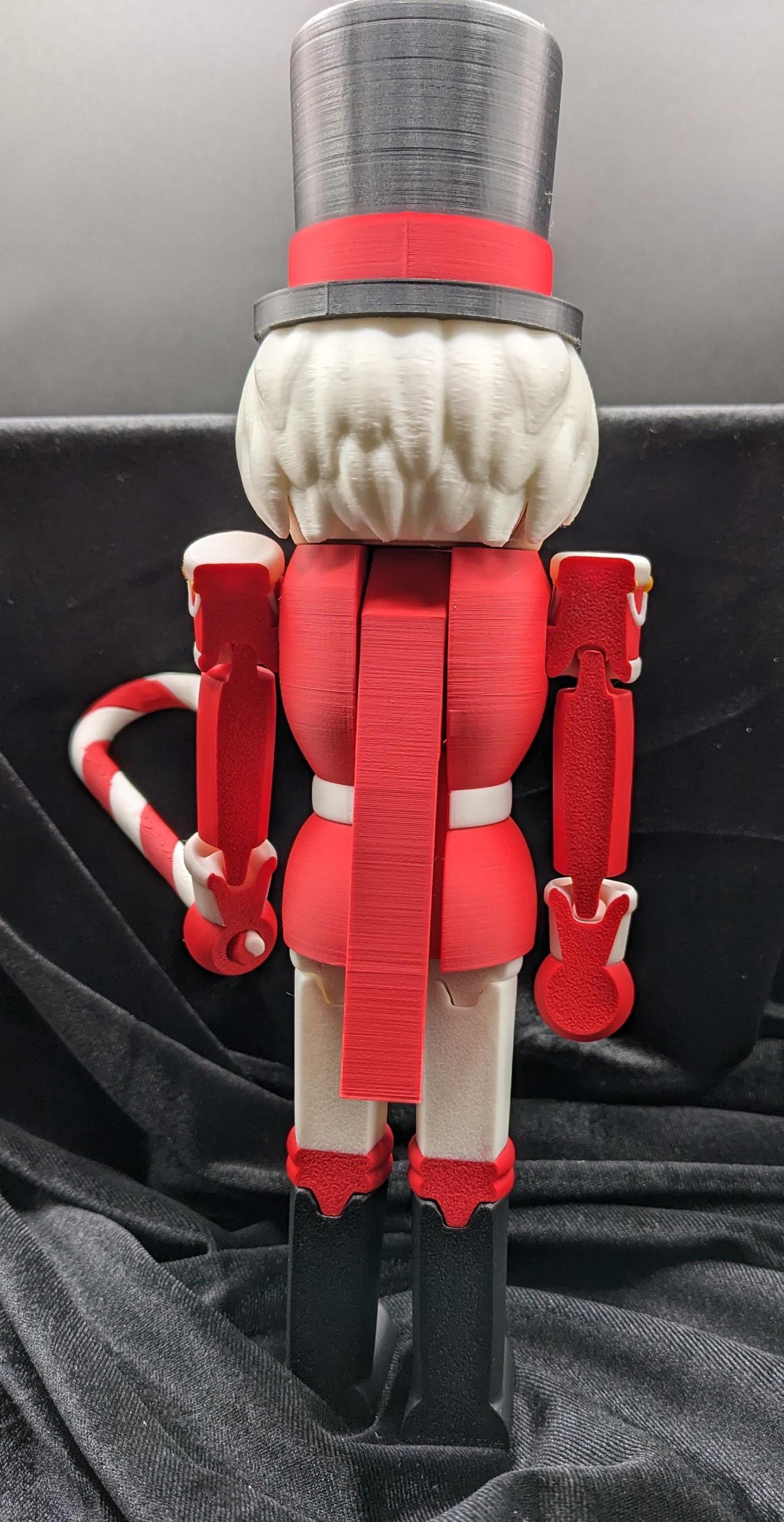 Celebrate the season with our Distinguished Articulated Christmas Nutcracker. Our handsome nutcrackers  can be posed to enhance its regal presence. Perfect for mantels, shelves, or as a centerpiece, a timeless addition to your holiday collection.