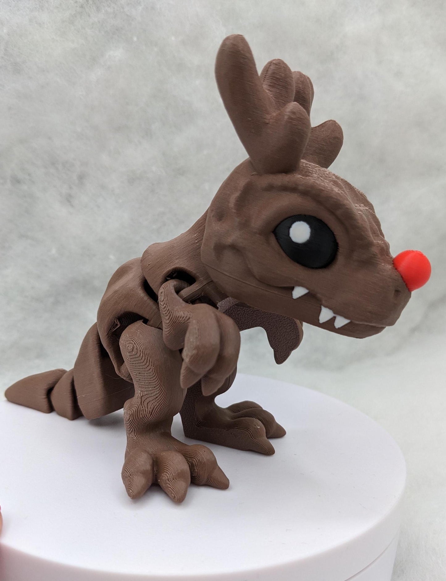 Our Christmas T-Rex combines the charm of Christmas with the fun of dinosaurs. An interactive toy for kids & adults alike,  articulated joints for posing & fidgeting, T-Rex is perfect as a stocking stuffer, desk toy, or playful holiday decoration.