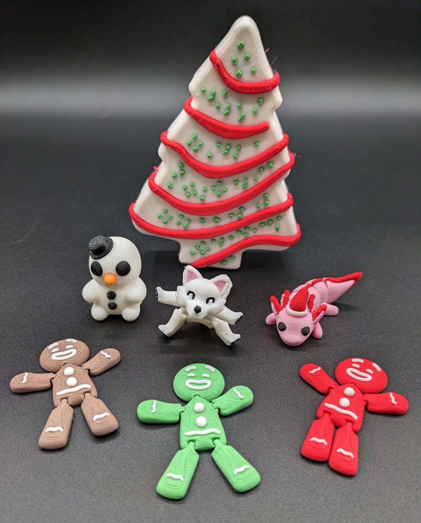 Add a delightful touch of holiday magic to your decor or gift-giving with our Yummy Christmas Tree Cake Container with 6 Mini Figures! This cute container is designed to look like a festive Christmas tree cake with 6 adorable mini figures!