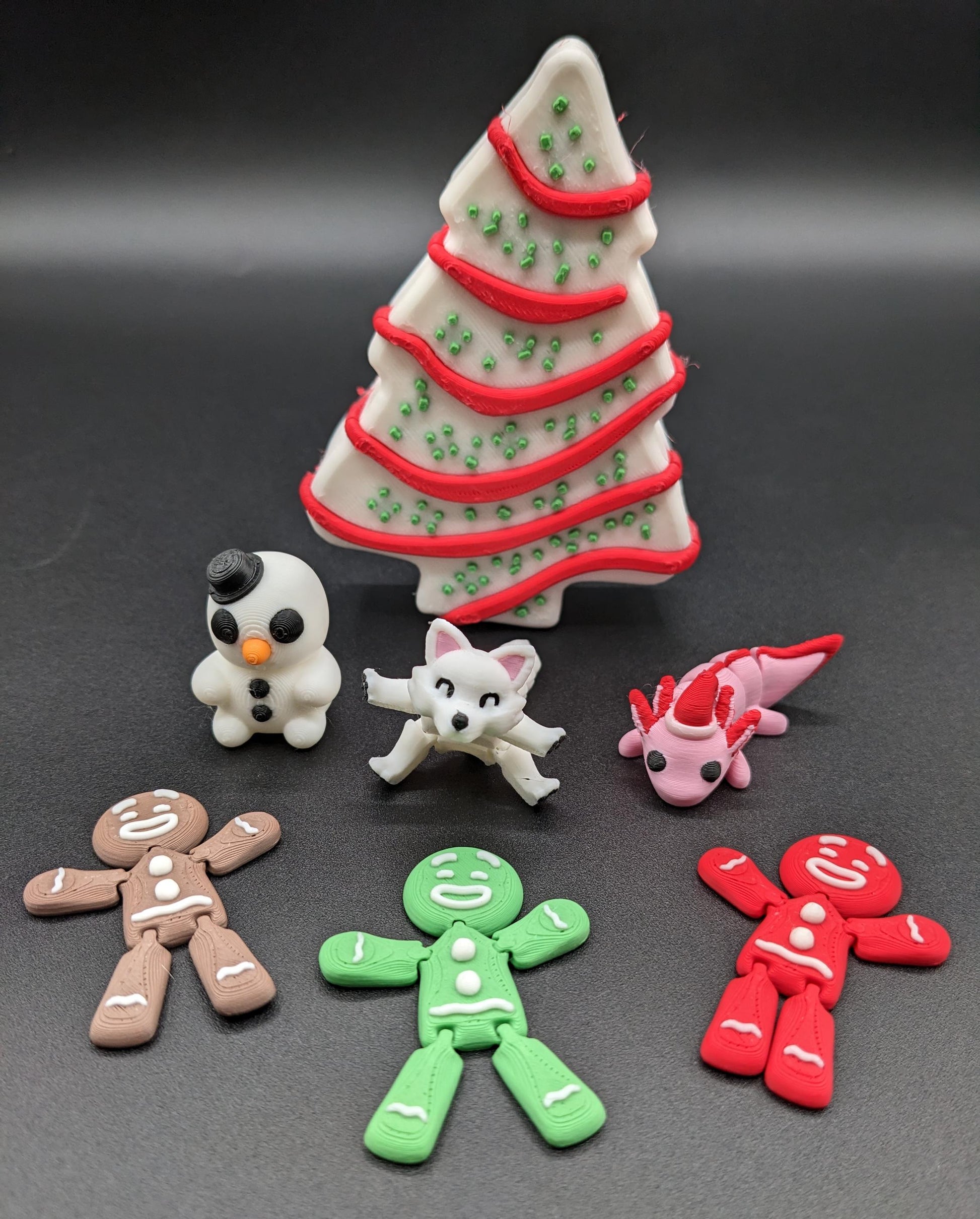 Add a delightful touch of holiday magic to your decor or gift-giving with our Yummy Christmas Tree Cake Container with 6 Mini Figures! This cute container is designed to look like a festive Christmas tree cake with 6 adorable mini figures!
