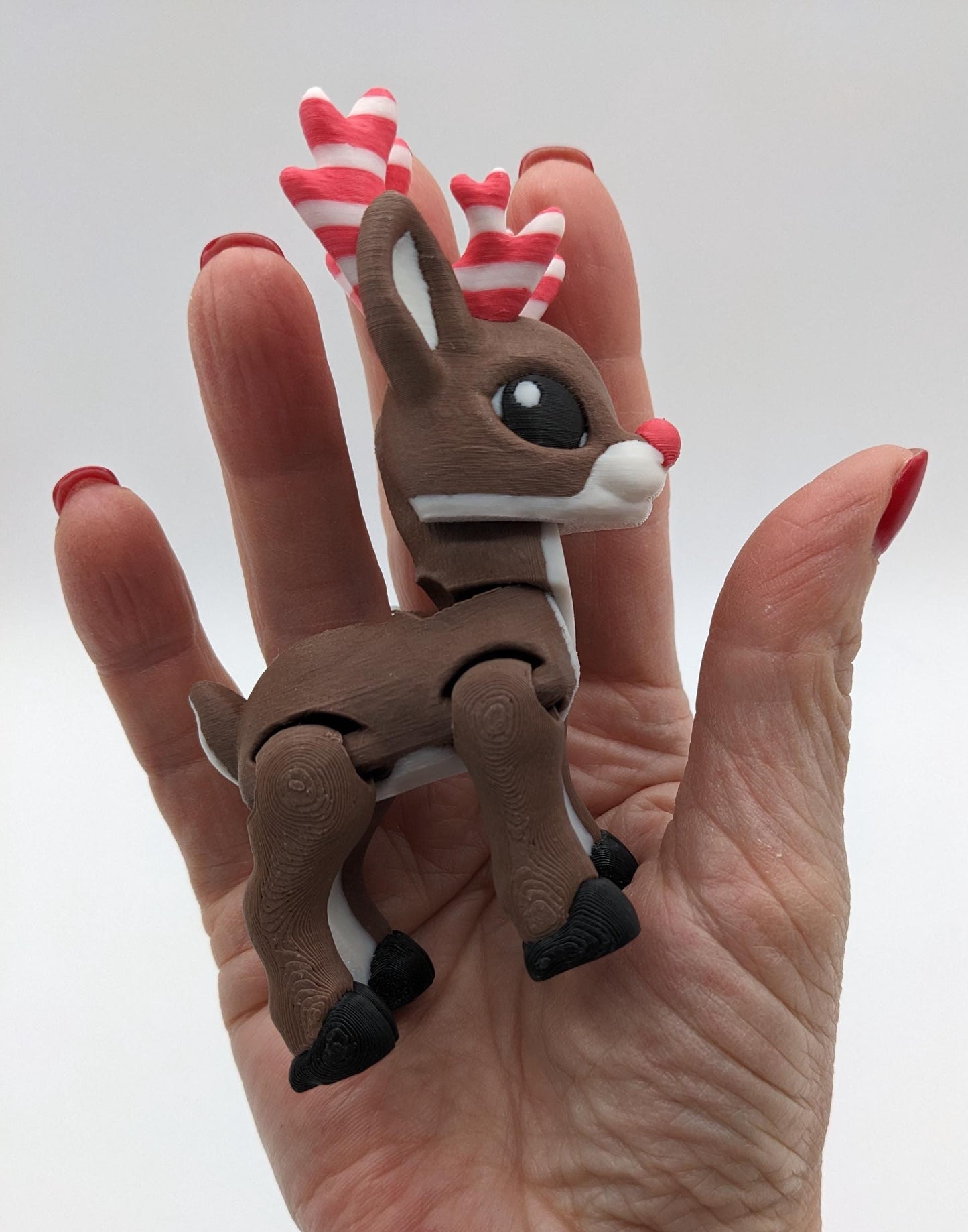 Our baby reindeer, inspired by holiday candy canes, is the perfect blend of fun & festive  creativity. Fully articulated & poseable body, this fidget toy is ideal for stress relief, creative play, or adding a whimsical touch to your Christmas decor.