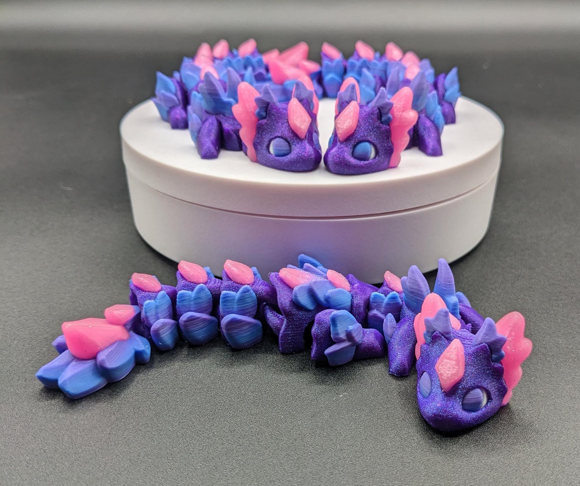 Whether you’re looking for a stress-relief toy, a whimsical desk companion, or a one-of-a-kind gift, Baby RubiKuro is here to charm kids, teens, & adults alike. Colorful, durable, & irresistibly adorable, our baby dragon is the perfect companion.