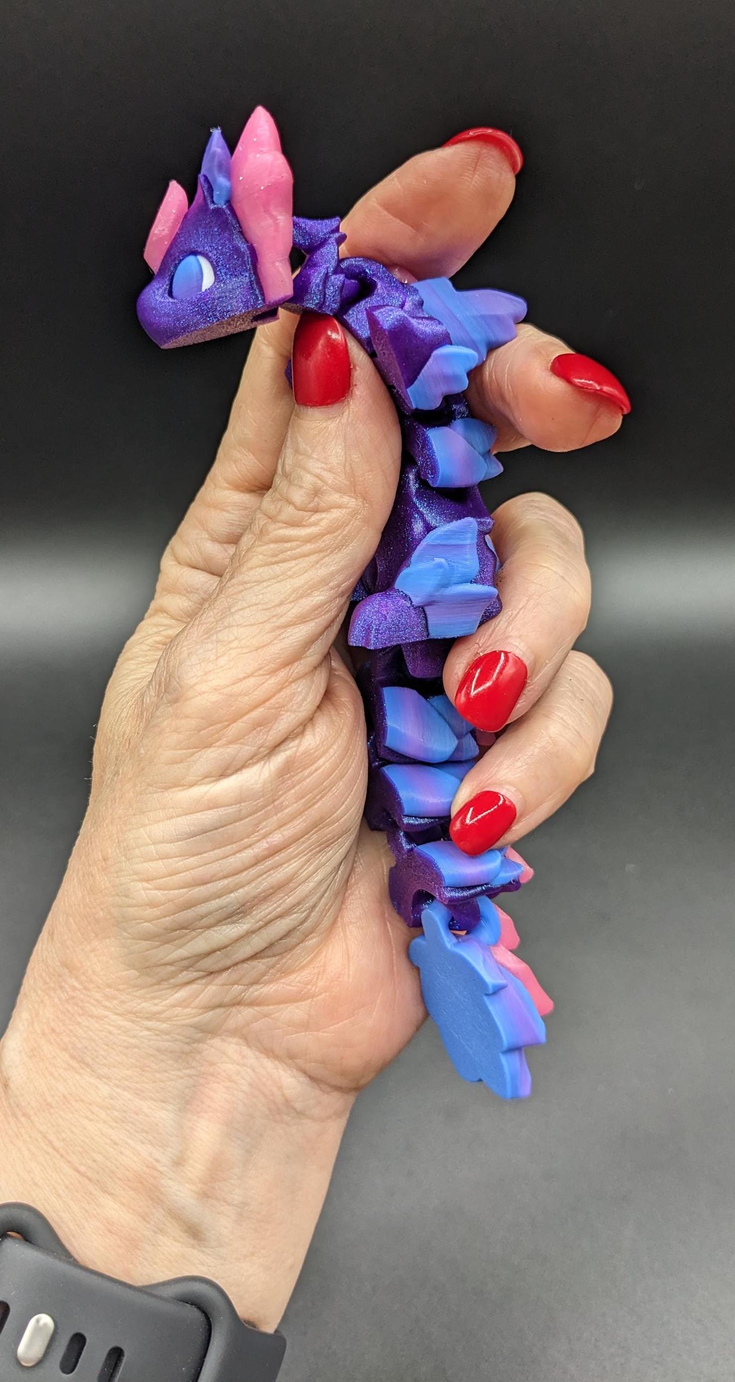 Whether you’re looking for a stress-relief toy, a whimsical desk companion, or a one-of-a-kind gift, Baby RubiKuro is here to charm kids, teens, & adults alike. Colorful, durable, & irresistibly adorable, our baby dragon is the perfect companion.