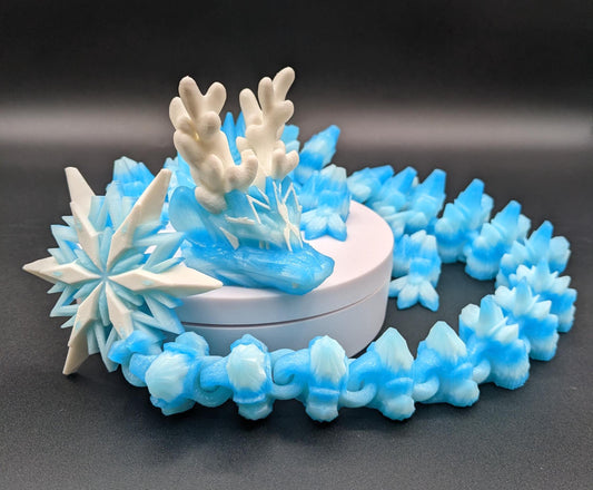 Embrace the wonder of winter with our Articulated Christmas Dragon. This stunning piece features movable joints, allowing you to pose it in various ways, enhancing its majestic presence. Color is icy translucent blue to add to the winter season.