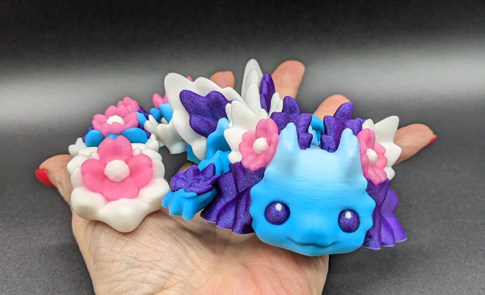 Let the Adorable Baby Kosha Axolotl Flower Dragon bring joy, relaxation, & a touch of enchantment into your life! Whether you’re treating yourself or someone special, this charming fidget toy is a delightful combination of fantasy & creativity.