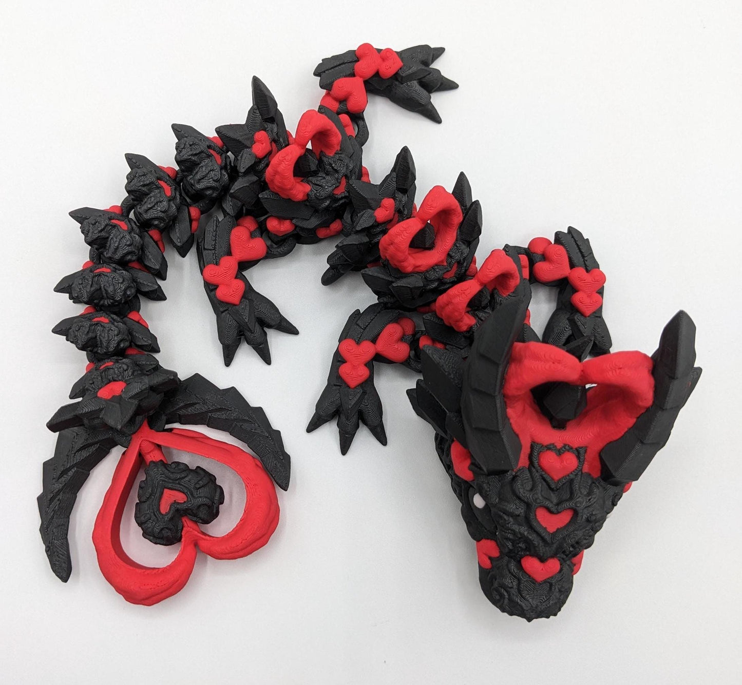 Meet the Elegant Articulated Baby Dark Heart Dragon, a stunning blend of mystery, grace, and intricate design. This captivating 3D-printed dragon is perfect for dragon enthusiasts, collectors, or anyone who loves unique and magical creations.