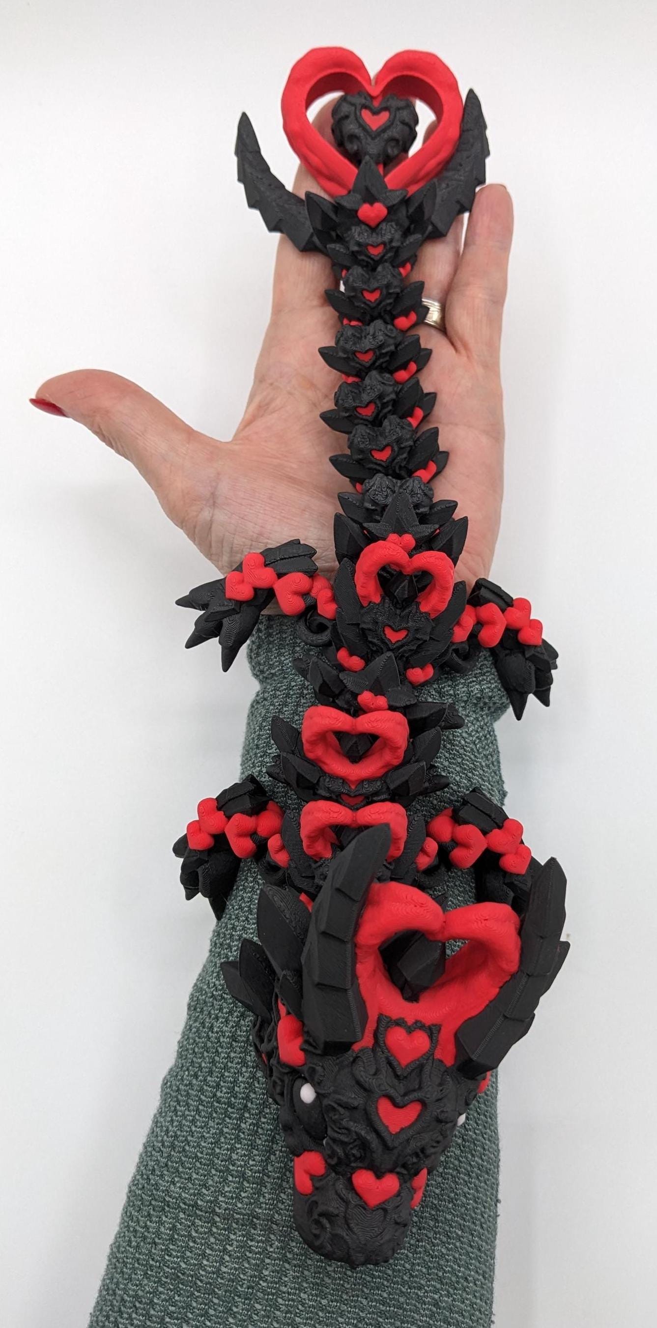 Meet the Elegant Articulated Baby Dark Heart Dragon, a stunning blend of mystery, grace, and intricate design. This captivating 3D-printed dragon is perfect for dragon enthusiasts, collectors, or anyone who loves unique and magical creations.