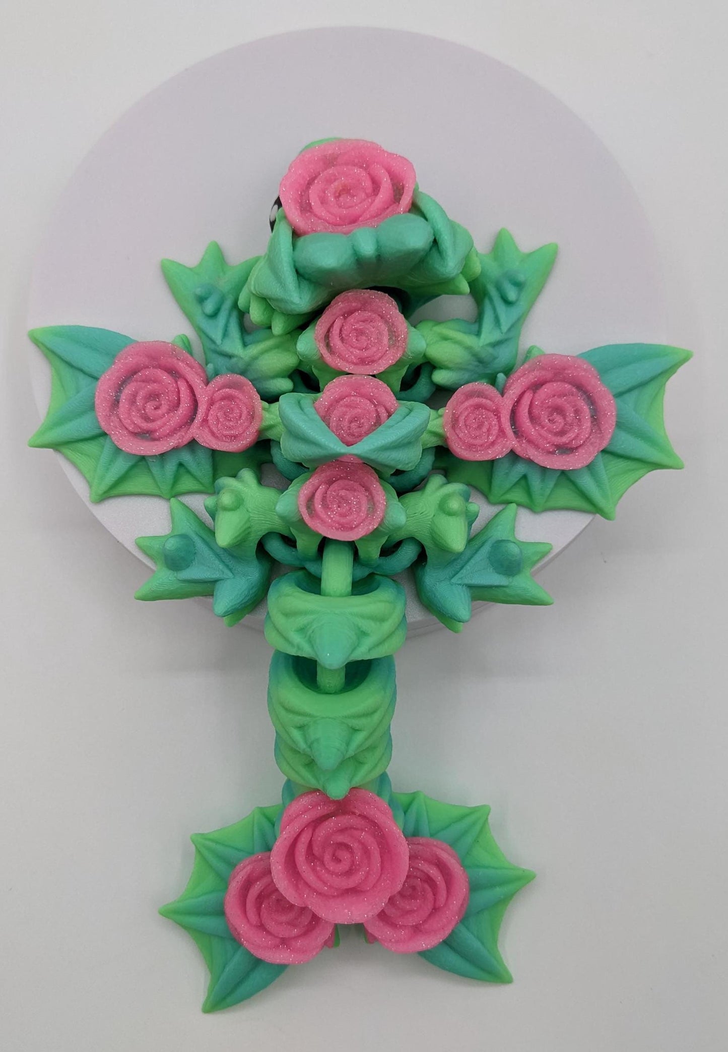 Add a touch of magic and charm to your day with the Adorable Articulated Baby Rose Dragon Fidget Toy! This enchanting 3D-printed dragon is inspired by the beauty of roses and the whimsical allure of baby dragons. The perfect Valentine's gift.