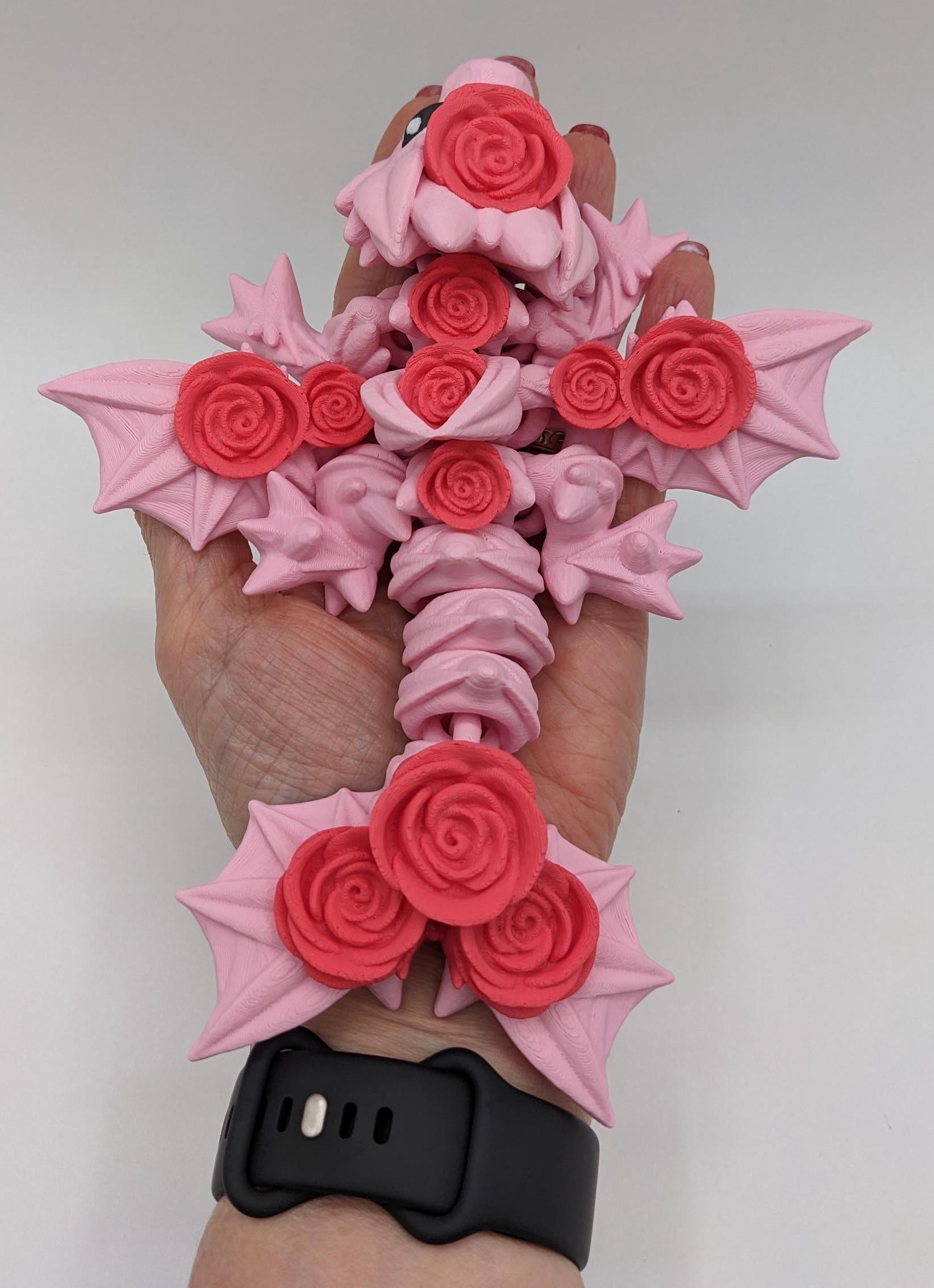 Add a touch of magic and charm to your day with the Adorable Articulated Baby Rose Dragon Fidget Toy! This enchanting 3D-printed dragon is inspired by the beauty of roses and the whimsical allure of baby dragons. The perfect Valentine's gift.