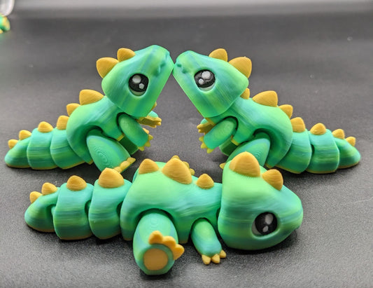 Our Adorable Articulated Baby Trex Flexi Fidget Toy is the perfect pet dinosaur! Our baby Trex  is designed to bring smiles, creativity, & stress relief to your daily routine. Perfect for fidgeting, imaginative play, or as a playful desk companion.