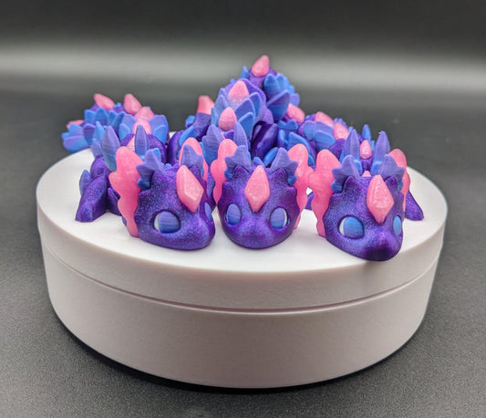 Whether you’re looking for a stress-relief toy, a whimsical desk companion, or a one-of-a-kind gift, Baby RubiKuro is here to charm kids, teens, & adults alike. Colorful, durable, & irresistibly adorable, our baby dragon is the perfect companion.