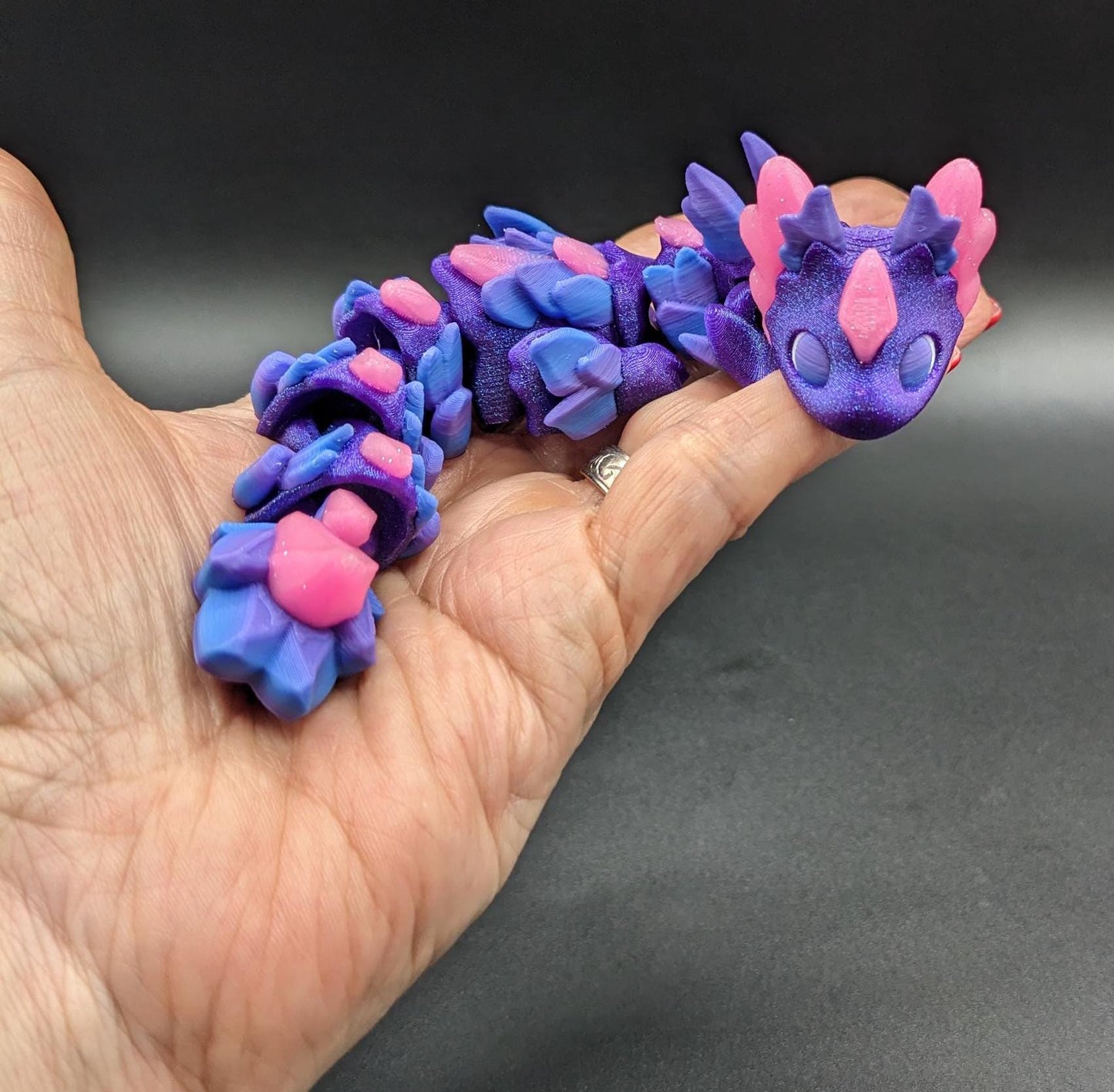 Whether you’re looking for a stress-relief toy, a whimsical desk companion, or a one-of-a-kind gift, Baby RubiKuro is here to charm kids, teens, & adults alike. Colorful, durable, & irresistibly adorable, our baby dragon is the perfect companion.