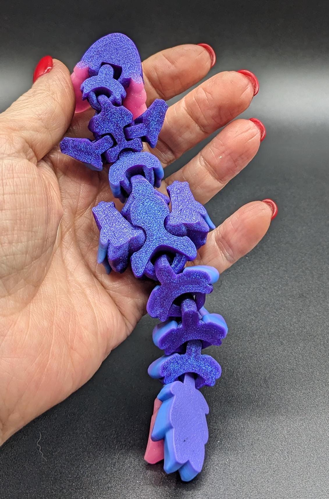 Whether you’re looking for a stress-relief toy, a whimsical desk companion, or a one-of-a-kind gift, Baby RubiKuro is here to charm kids, teens, & adults alike. Colorful, durable, & irresistibly adorable, our baby dragon is the perfect companion.