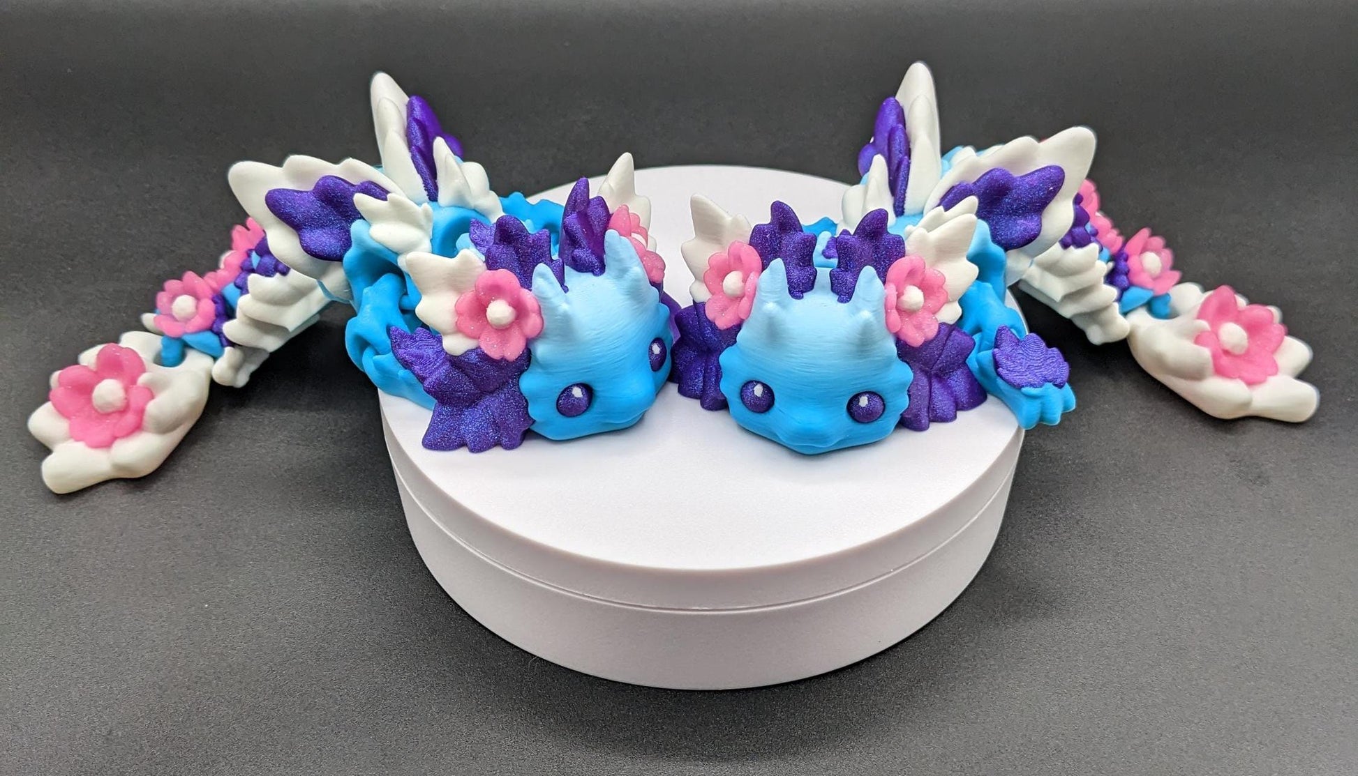 Let the Adorable Baby Kosha Axolotl Flower Dragon bring joy, relaxation, & a touch of enchantment into your life! Whether you’re treating yourself or someone special, this charming fidget toy is a delightful combination of fantasy & creativity.