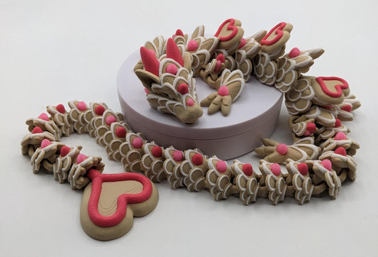 Celebrate love with the Large Articulated Valentine’s Heart Cookie Dragon Fidget Toy! This delightful 3D-printed dragon is inspired by the sweetness of cookies & the magic of Valentine’s Day, making it the perfect gift for someone you love.