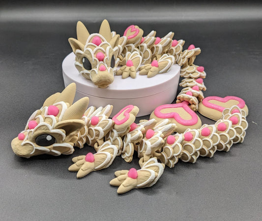 Our adorable 3D-printed dragon combines the whimsical charm of gingerbread cookies, heart-shaped details, & the playful personality of a baby dragon. Whether it’s a holiday gift, an enchanted companion, or a fun fidget toy, this dragon is perfect!