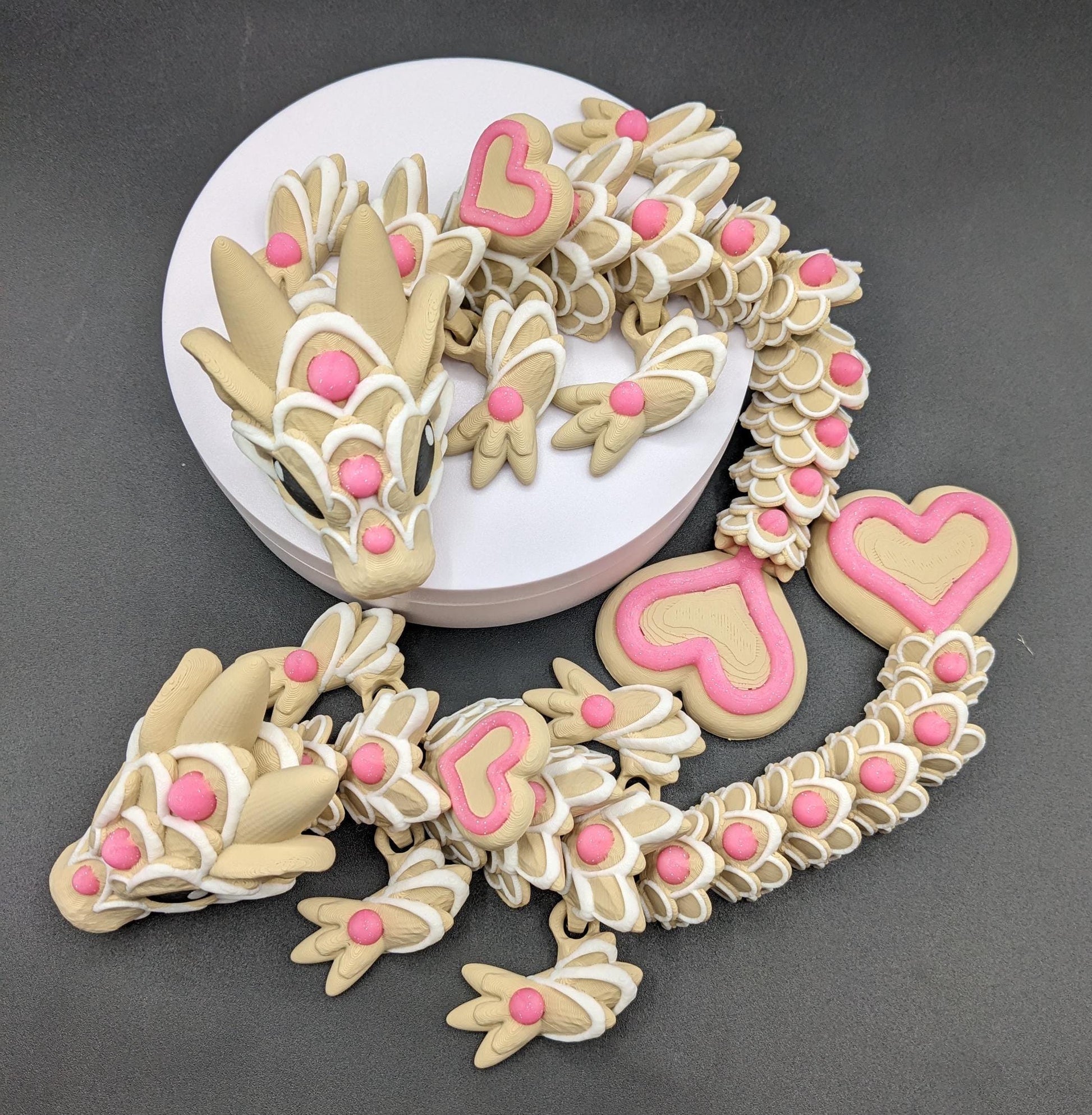 Our adorable 3D-printed dragon combines the whimsical charm of gingerbread cookies, heart-shaped details, & the playful personality of a baby dragon. Whether it’s a holiday gift, an enchanted companion, or a fun fidget toy, this dragon is perfect!