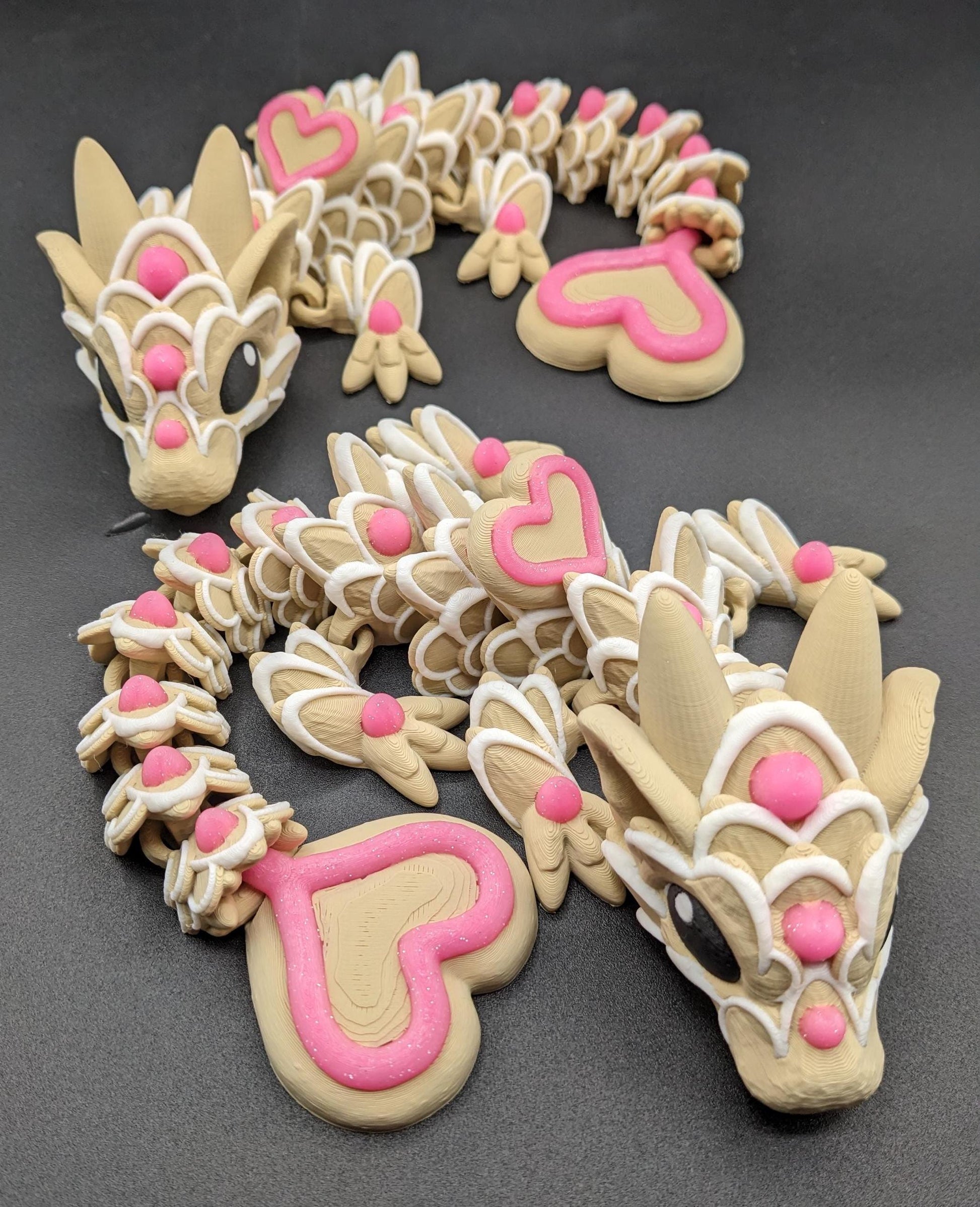 Our adorable 3D-printed dragon combines the whimsical charm of gingerbread cookies, heart-shaped details, & the playful personality of a baby dragon. Whether it’s a holiday gift, an enchanted companion, or a fun fidget toy, this dragon is perfect!