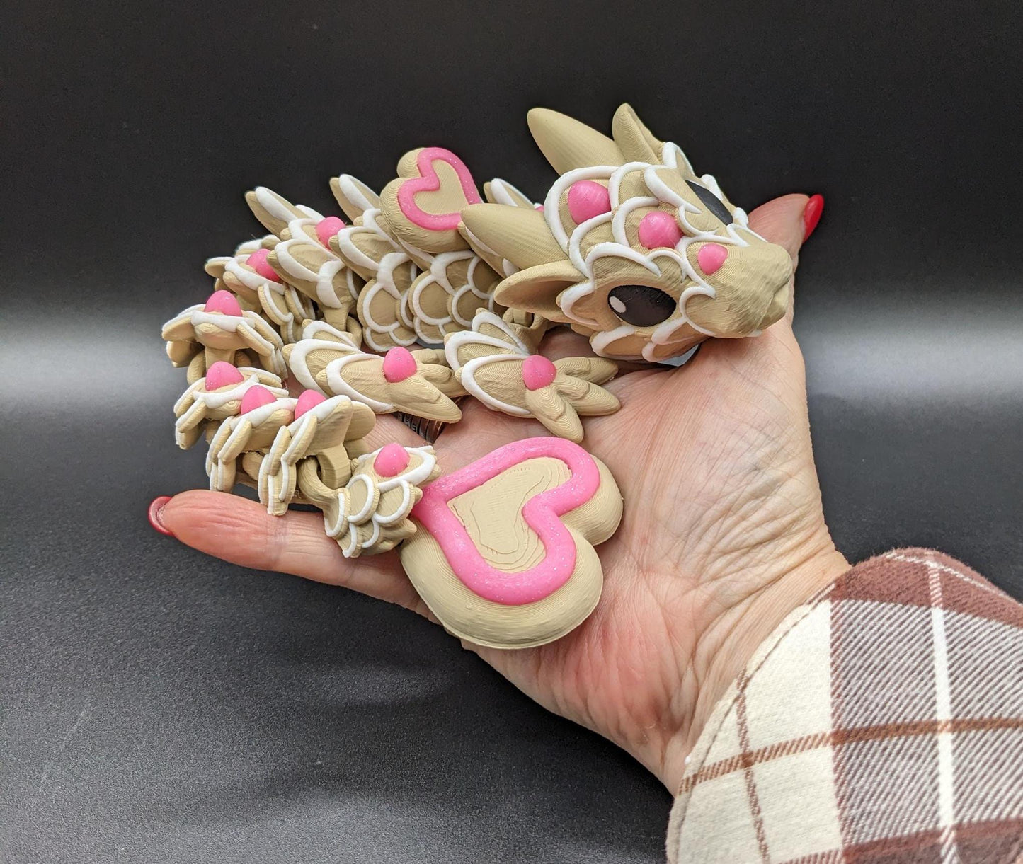 Our adorable 3D-printed dragon combines the whimsical charm of gingerbread cookies, heart-shaped details, & the playful personality of a baby dragon. Whether it’s a holiday gift, an enchanted companion, or a fun fidget toy, this dragon is perfect!