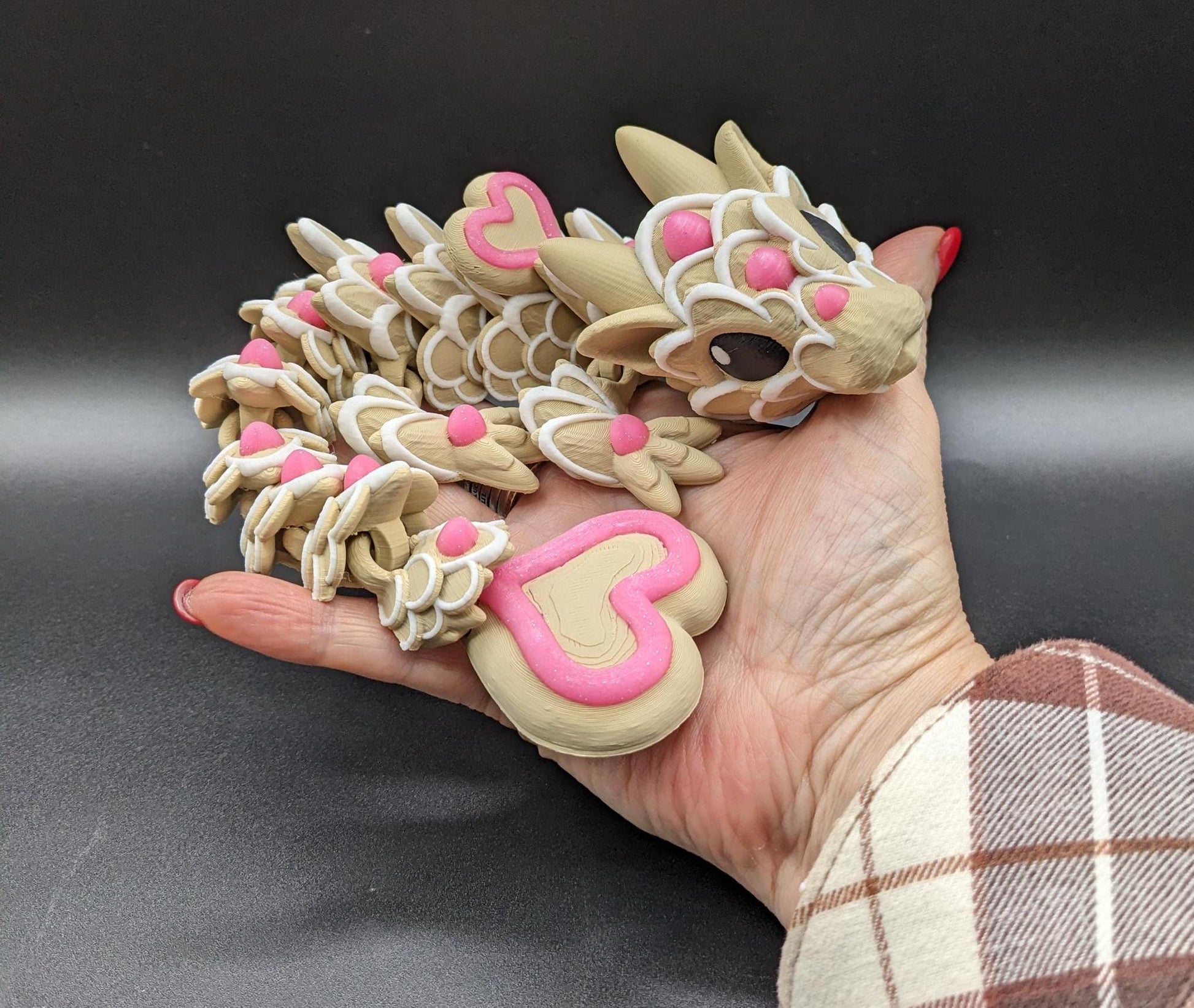 Our adorable 3D-printed dragon combines the whimsical charm of gingerbread cookies, heart-shaped details, & the playful personality of a baby dragon. Whether it’s a holiday gift, an enchanted companion, or a fun fidget toy, this dragon is perfect!