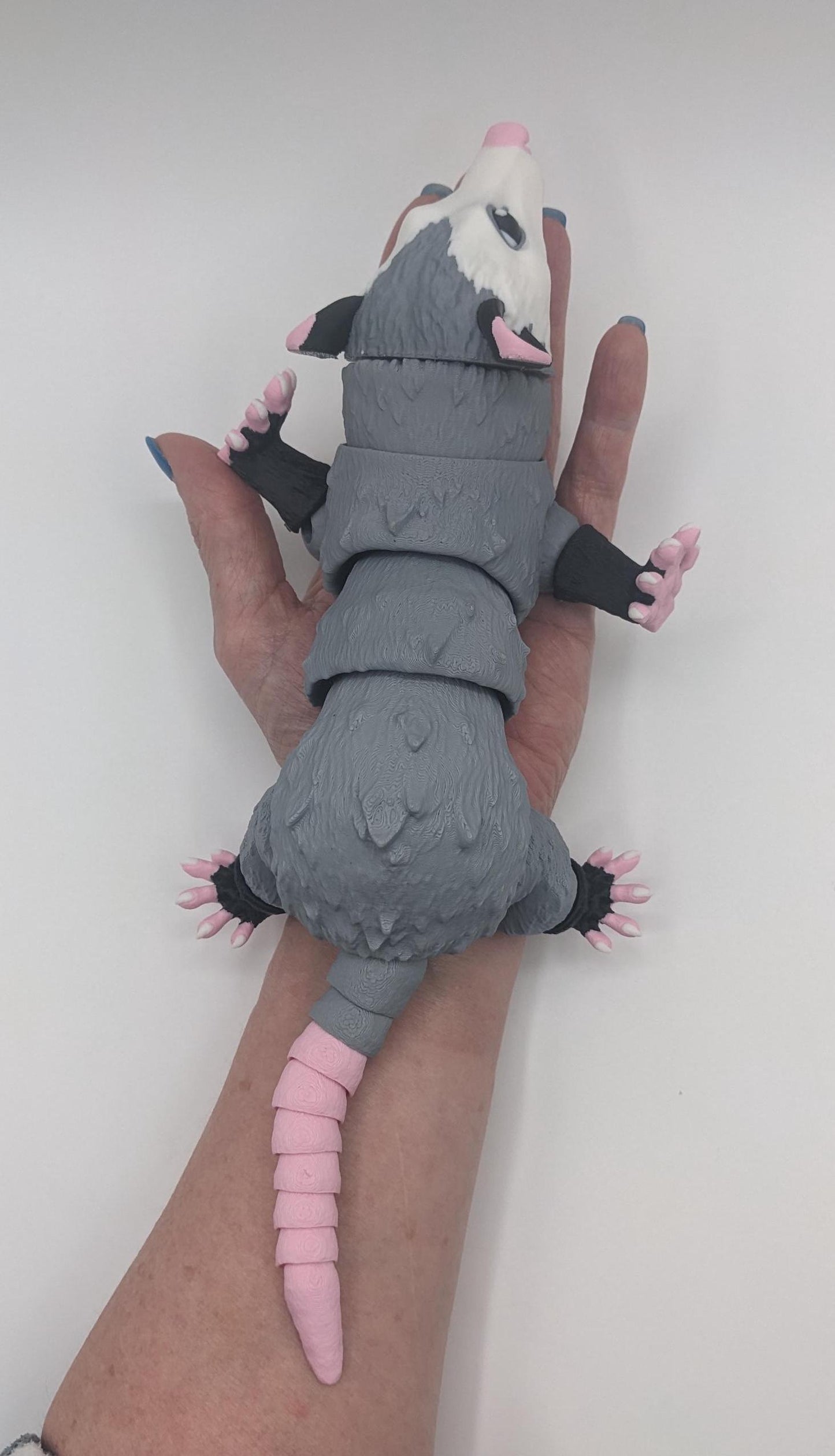 Bring a little mischief and charm to your life with the Articulated Opossum Toy Fidget! This adorable 3D-printed creation is perfect for opossum lovers, fidget toy enthusiasts, or anyone looking for a unique and playful stress reliever.