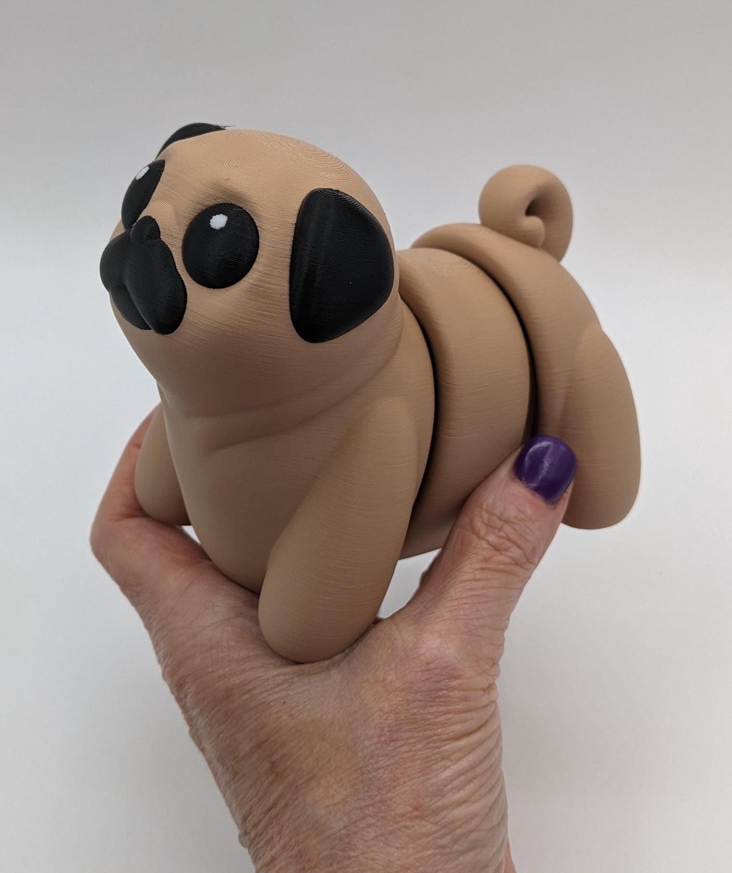 Man's best friend & the clown of the dog breeds, our adorable pug with it's larger size makes it even more fun to handle, while capturing the mischievous charm of your puggy friend. Whether you’re looking for a unique gift, a relaxing fidget toy, or a playful decoration, this pug puppy will bring endless joy & stress relief.