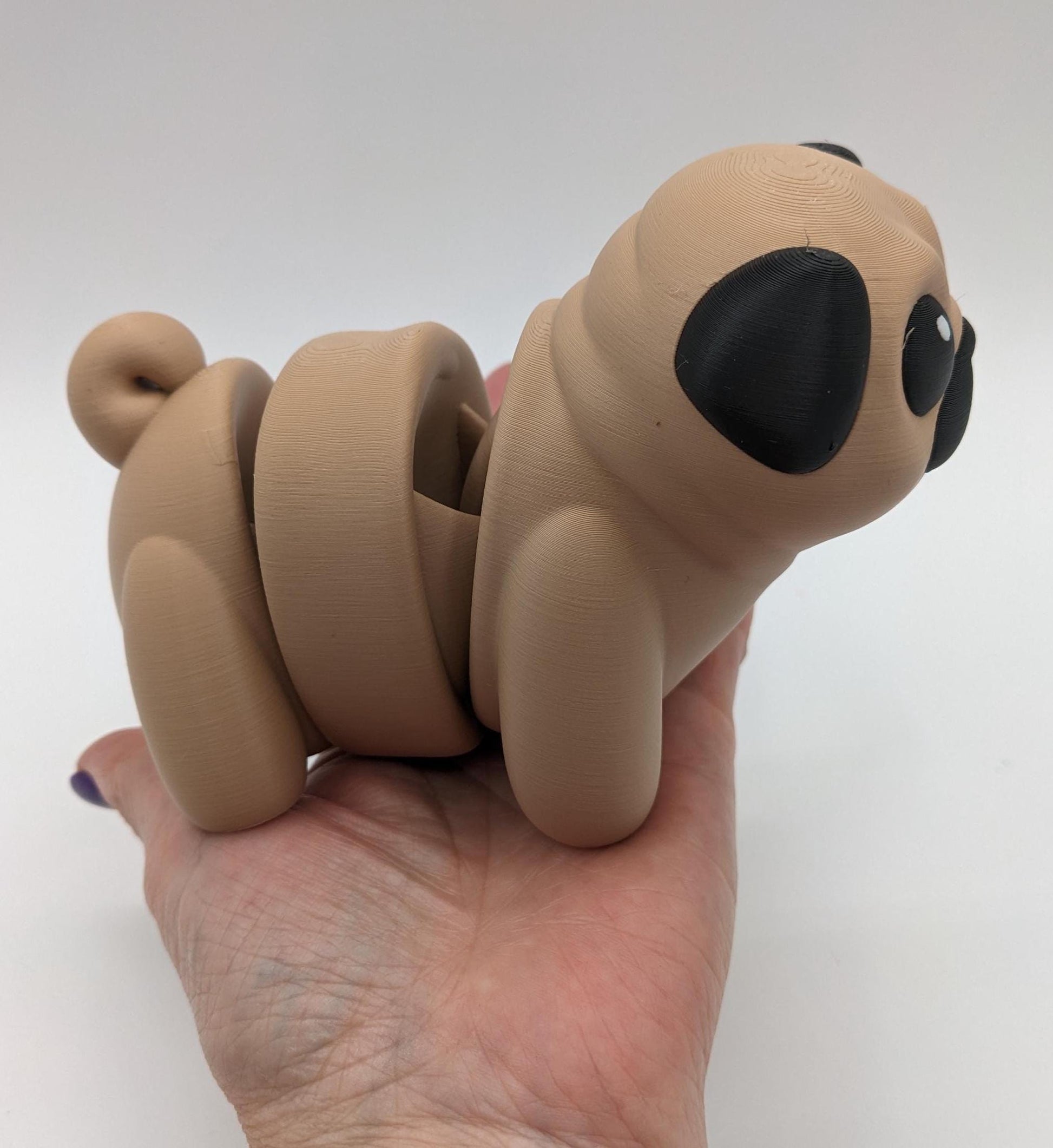 Man's best friend & the clown of the dog breeds, our adorable pug with it's larger size makes it even more fun to handle, while capturing the mischievous charm of your puggy friend. Whether you’re looking for a unique gift, a relaxing fidget toy, or a playful decoration, this pug puppy will bring endless joy & stress relief.