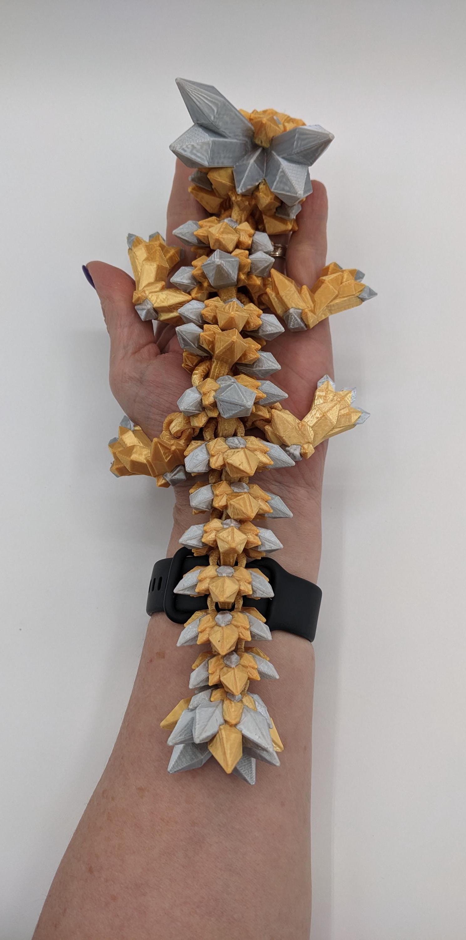 Bring a touch of magic to your life with the Adorable Articulated Baby Crystal Dragon! This 3D-printed masterpiece is designed with intricate details and fully articulated joints, making it a playful and poseable collectible that’s perfect for dragon lovers, fantasy fans, and unique gift seekers. Inspired by the elegance of crystals and the charm of baby dragons, this figurine is both whimsical and eye-catching.