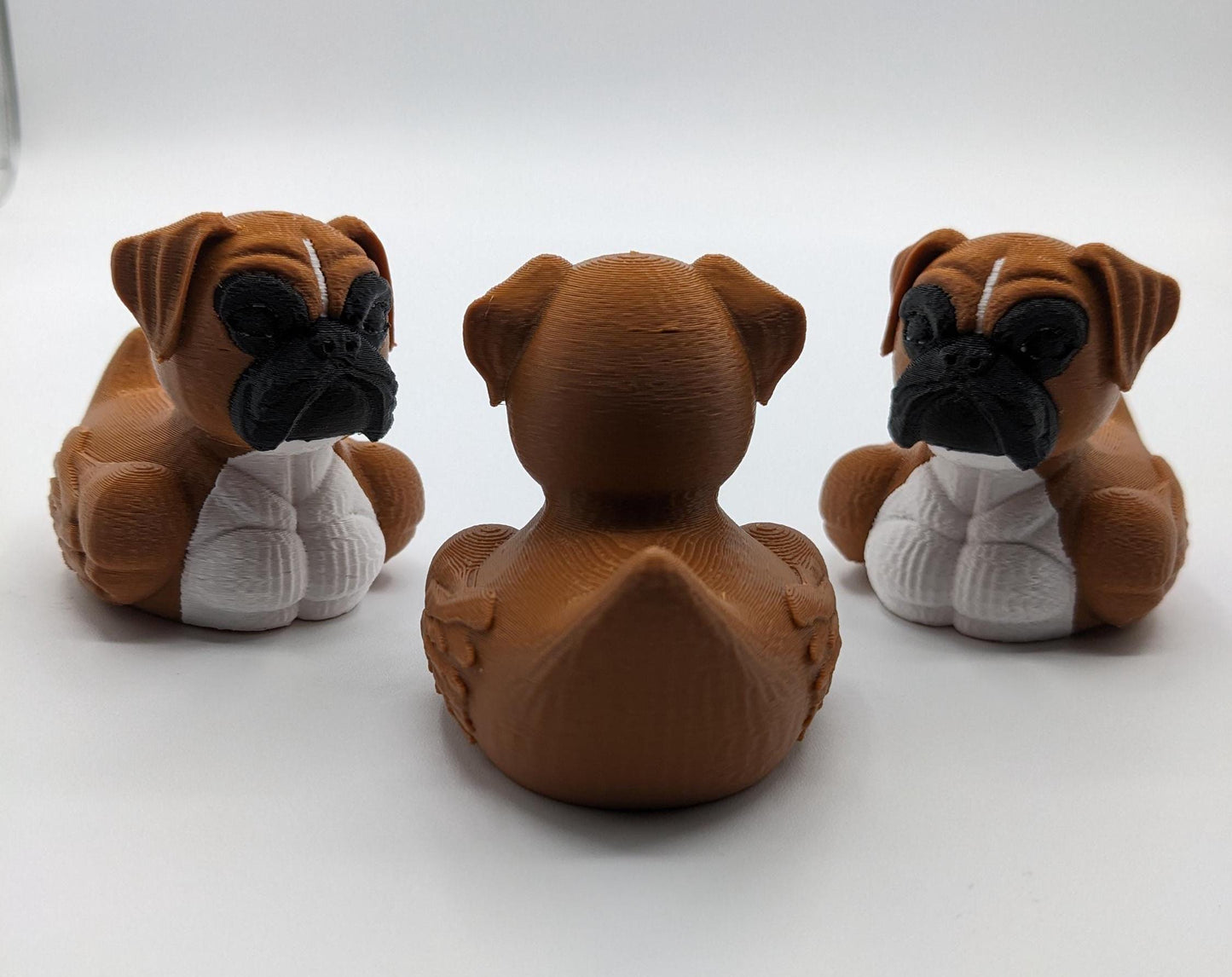 Meet The Magnificent Boxer Duck, a creative and charming 3D-printed hybrid that combines the strong, playful personality of a Boxer dog with the whimsical charm of a duck! This one-of-a-kind figurine is perfect for Boxer lovers, dog enthusiasts, Jeep duck collectors, or anyone who enjoys quirky and imaginative decor. Whether displayed on a shelf, a Jeep dash, added to your collection, or given as a thoughtful gift, this Boxer Duck is guaranteed to bring smiles and brighten up any room.