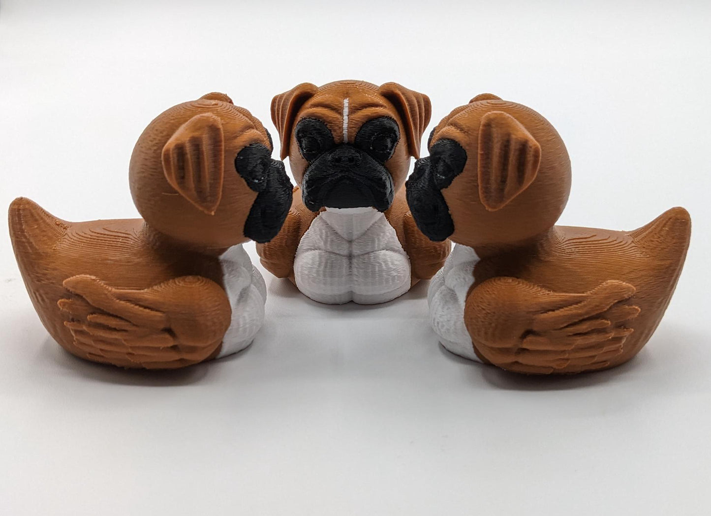 Meet The Magnificent Boxer Duck, a creative and charming 3D-printed hybrid that combines the strong, playful personality of a Boxer dog with the whimsical charm of a duck! This one-of-a-kind figurine is perfect for Boxer lovers, dog enthusiasts, Jeep duck collectors, or anyone who enjoys quirky and imaginative decor. Whether displayed on a shelf, a Jeep dash, added to your collection, or given as a thoughtful gift, this Boxer Duck is guaranteed to bring smiles and brighten up any room.