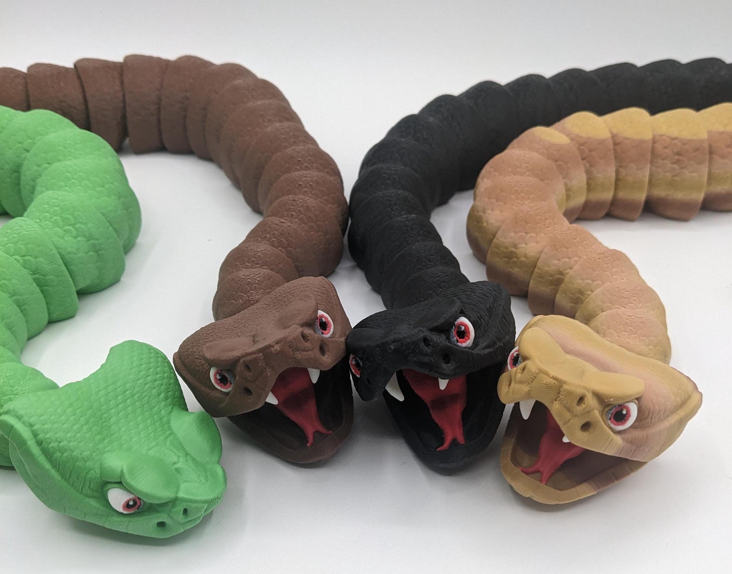 Unleash the charm of the wild with the Articulated Rattlesnake Fidget Toy, a unique 3D-printed creation that’s fun, flexible, and incredibly satisfying to play with! Designed with intricate details, this articulated rattlesnake moves and bends smoothly, providing endless entertainment and stress relief for kids, teens, and adults. Whether you're a fidget toy enthusiast, a snake lover, or just looking for a creative gift, this rattlesnake is guaranteed to be a hit.