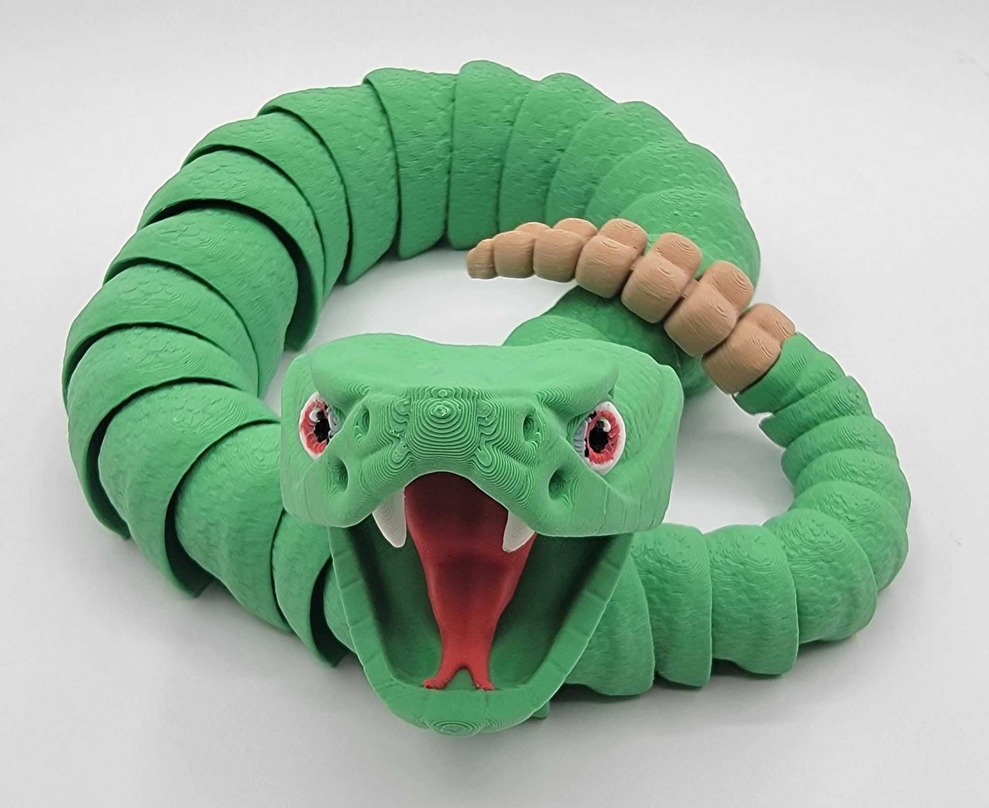 Unleash the charm of the wild with the Articulated Rattlesnake Fidget Toy, a unique 3D-printed creation that’s fun, flexible, and incredibly satisfying to play with! Designed with intricate details, this articulated rattlesnake moves and bends smoothly, providing endless entertainment and stress relief for kids, teens, and adults. Whether you're a fidget toy enthusiast, a snake lover, or just looking for a creative gift, this rattlesnake is guaranteed to be a hit.