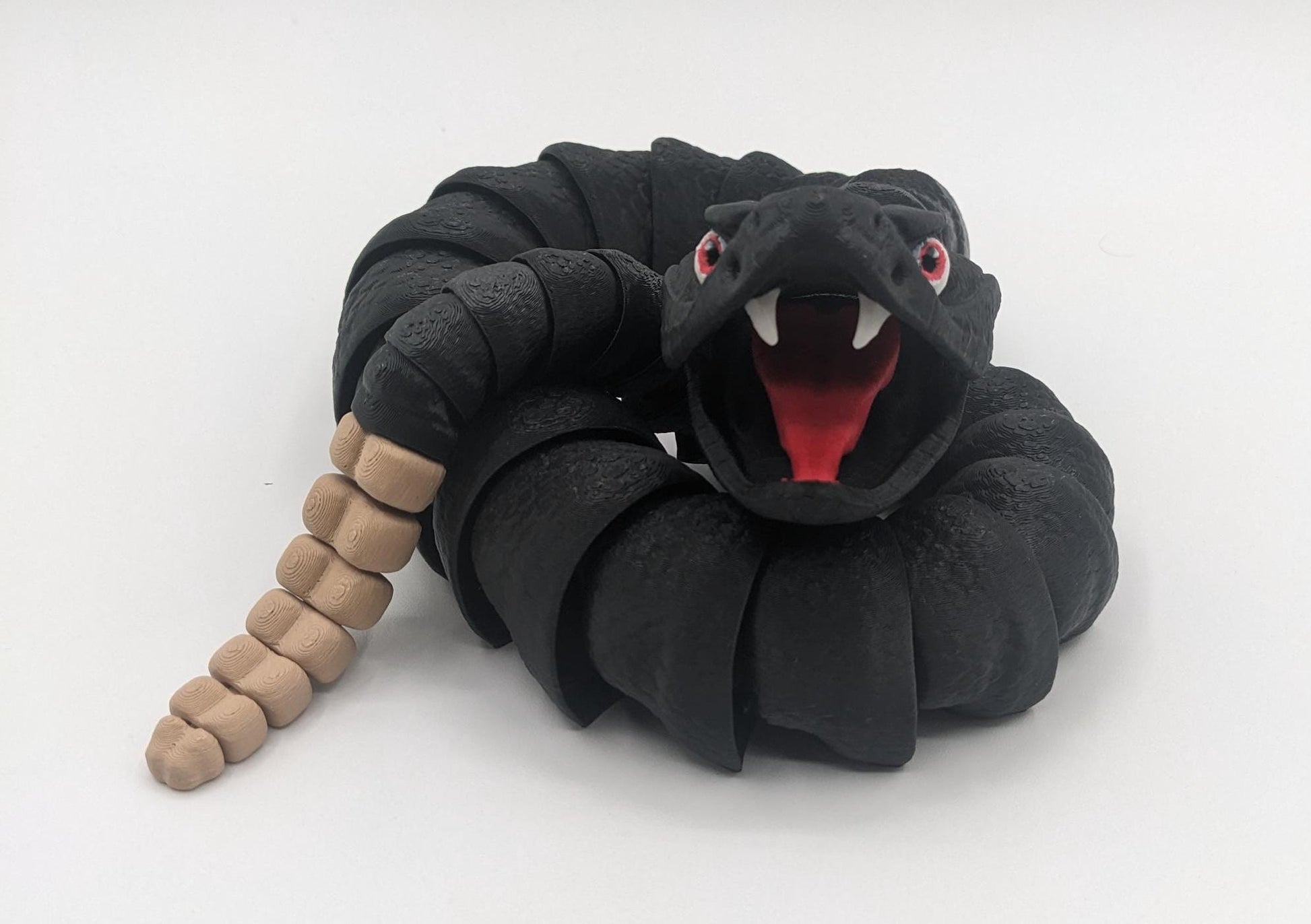 Unleash the charm of the wild with the Articulated Rattlesnake Fidget Toy, a unique 3D-printed creation that’s fun, flexible, and incredibly satisfying to play with! Designed with intricate details, this articulated rattlesnake moves and bends smoothly, providing endless entertainment and stress relief for kids, teens, and adults. Whether you're a fidget toy enthusiast, a snake lover, or just looking for a creative gift, this rattlesnake is guaranteed to be a hit.
