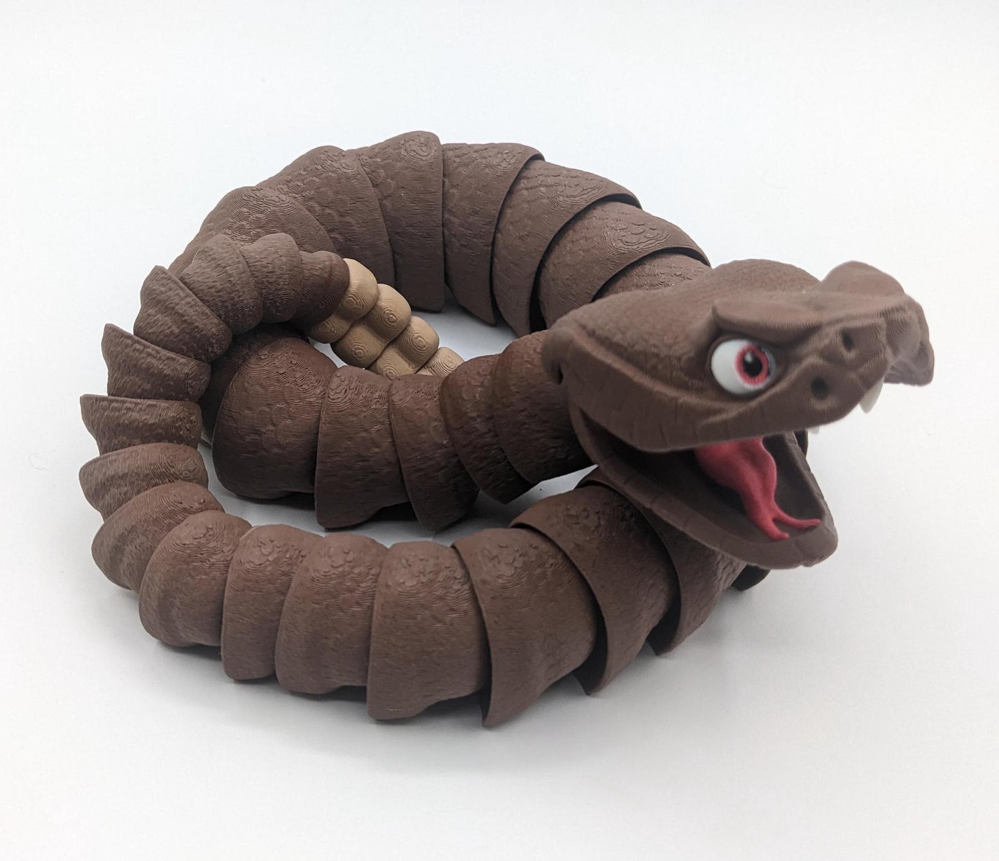 Unleash the charm of the wild with the Articulated Rattlesnake Fidget Toy, a unique 3D-printed creation that’s fun, flexible, and incredibly satisfying to play with! Designed with intricate details, this articulated rattlesnake moves and bends smoothly, providing endless entertainment and stress relief for kids, teens, and adults. Whether you're a fidget toy enthusiast, a snake lover, or just looking for a creative gift, this rattlesnake is guaranteed to be a hit.