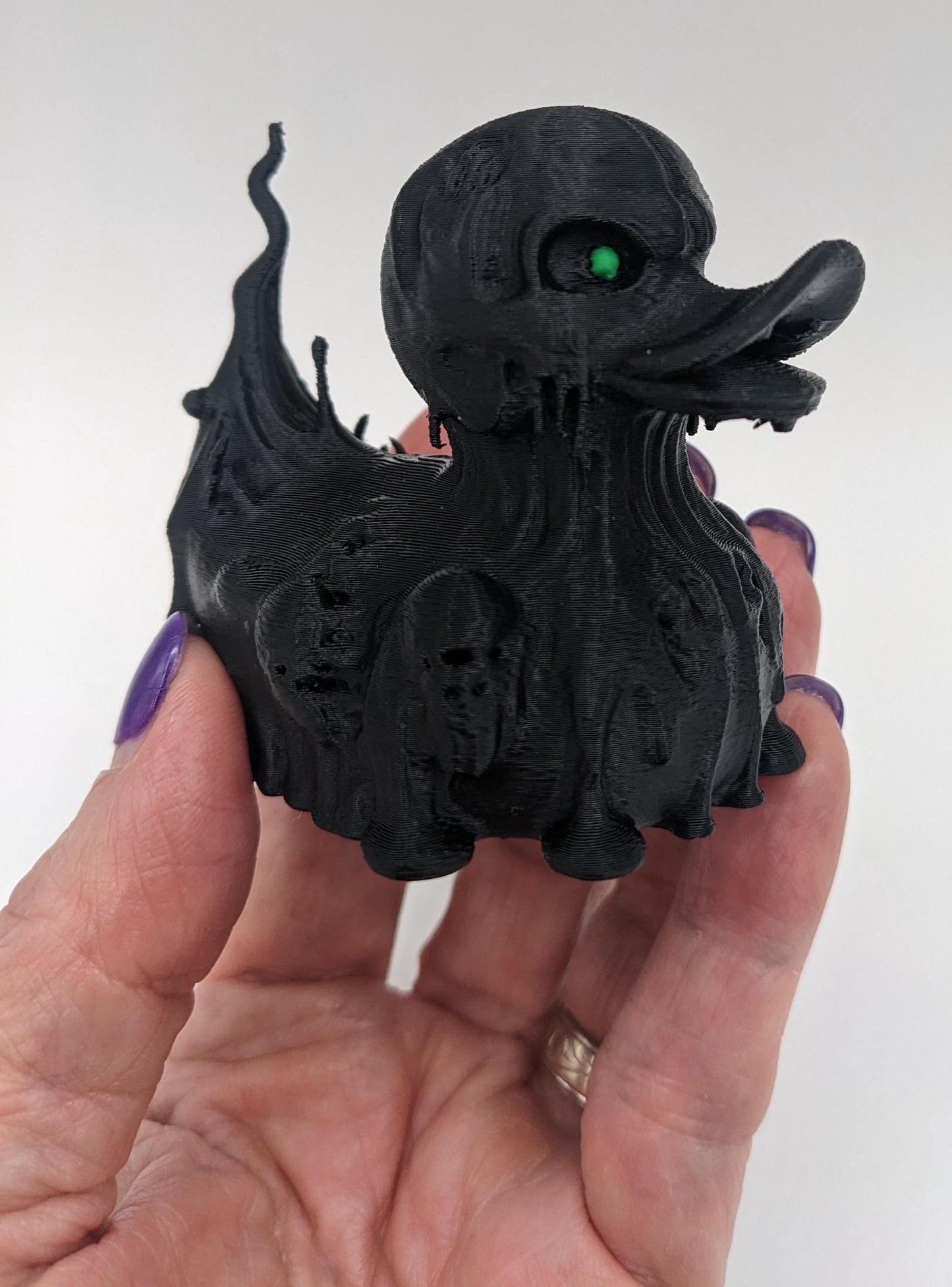 Meet our Scary Evil Spirit Duck, a spooky, quirky 3D-printed, (not painted), creation combining a classic duck with a haunting twist. It's creepy design & eerie features, this duck is perfect for Halloween decor, horror enthusiasts, Jeep duck collectors, or anyone who loves  spooky collectibles. Whether displayed on the dash of your Jeep, perched on your shelf, added to your haunted decorations, or gifted to a lover of the macabre, this evil spirit duck is guaranteed to make a scary statement!