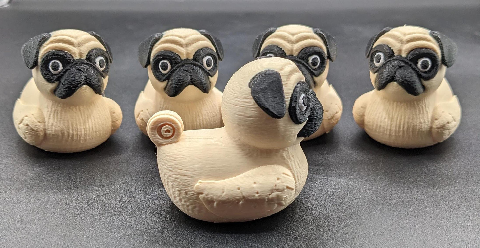 Meet The Fabulous Pug Dog Duck, a delightful 3D-printed creation that combines the charm of a pug with the whimsy of a rubber duck! This quirky and adorable design is perfect for pug lovers, Jeep duck collectors, duck enthusiasts, or anyone who enjoys playful and unique decor. Whether it’s displayed on a shelf, on the dash of your car, used as a conversation starter, or gifted to a dog or Jeep lover, this pug duck is guaranteed to bring smiles and laughter.