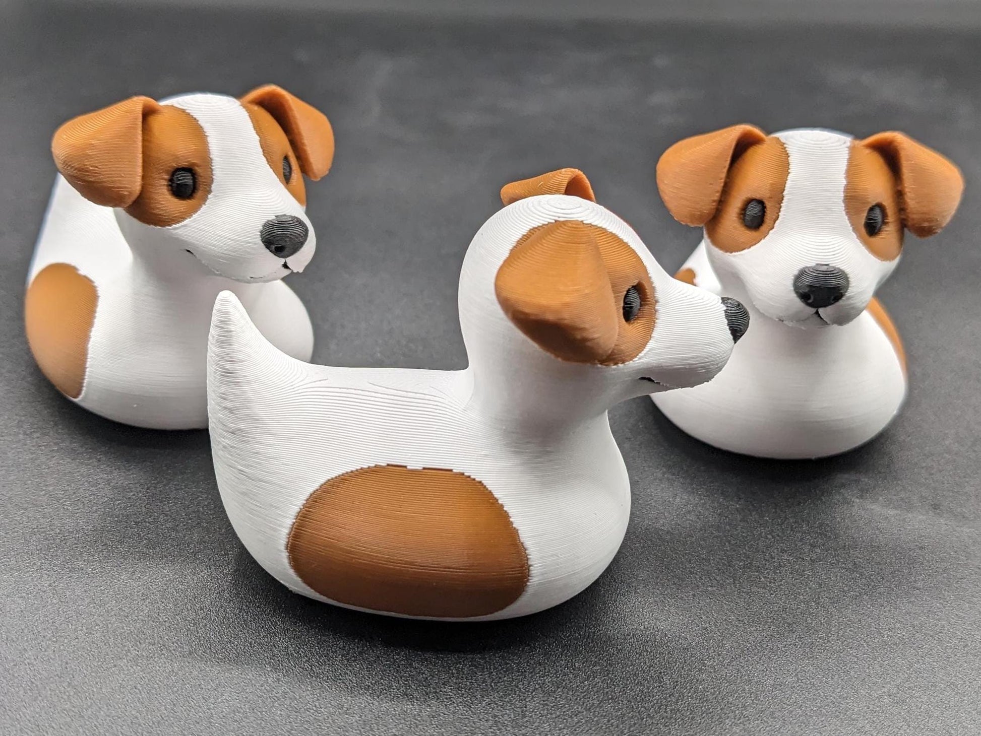 All our ducks are printed in PETG filament, a more expensive filament without the upcharge, as PETG is UV stable, heat and moisture tolerant. PLA color will fade if left on the dash of a car or in direct sunlight. Say hello to the Friendly Jack Russell Terrier Dog Duck Toy, the perfect blend of playful charm and quirky creativity! Whether you’re a dog lover, a Jeep duck collector, or simply someone who enjoys unique and fun decor, this adorable hybrid toy is sure to bring a smile to your face.