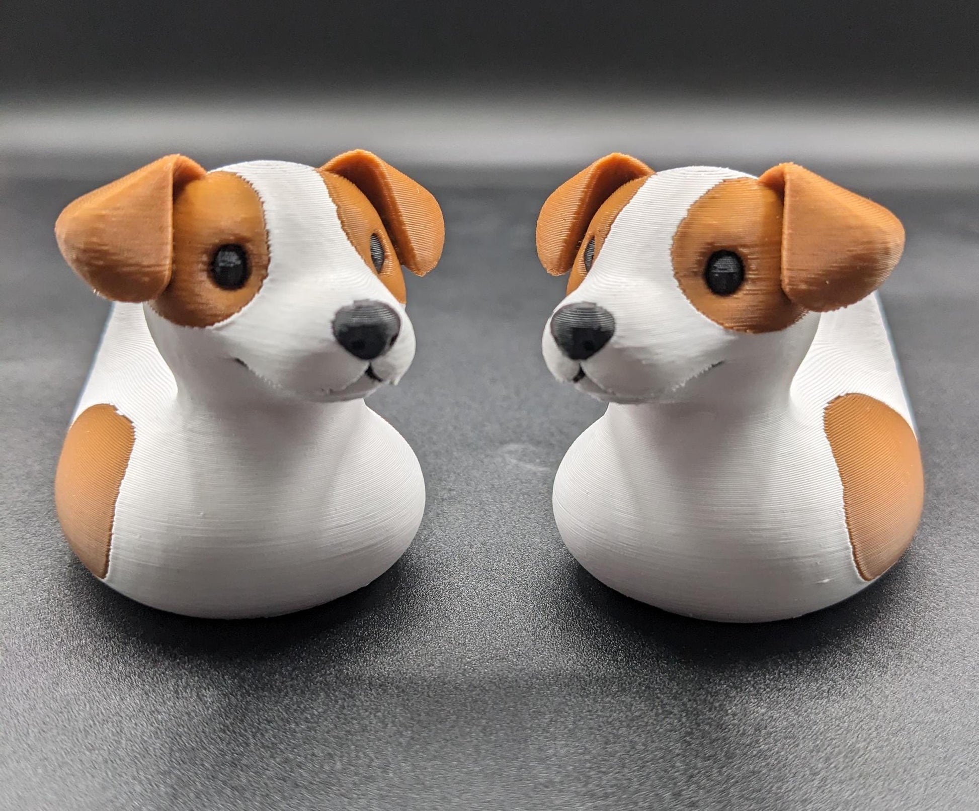 All our ducks are printed in PETG filament, a more expensive filament without the upcharge, as PETG is UV stable, heat and moisture tolerant. PLA color will fade if left on the dash of a car or in direct sunlight. Say hello to the Friendly Jack Russell Terrier Dog Duck Toy, the perfect blend of playful charm and quirky creativity! Whether you’re a dog lover, a Jeep duck collector, or simply someone who enjoys unique and fun decor, this adorable hybrid toy is sure to bring a smile to your face.
