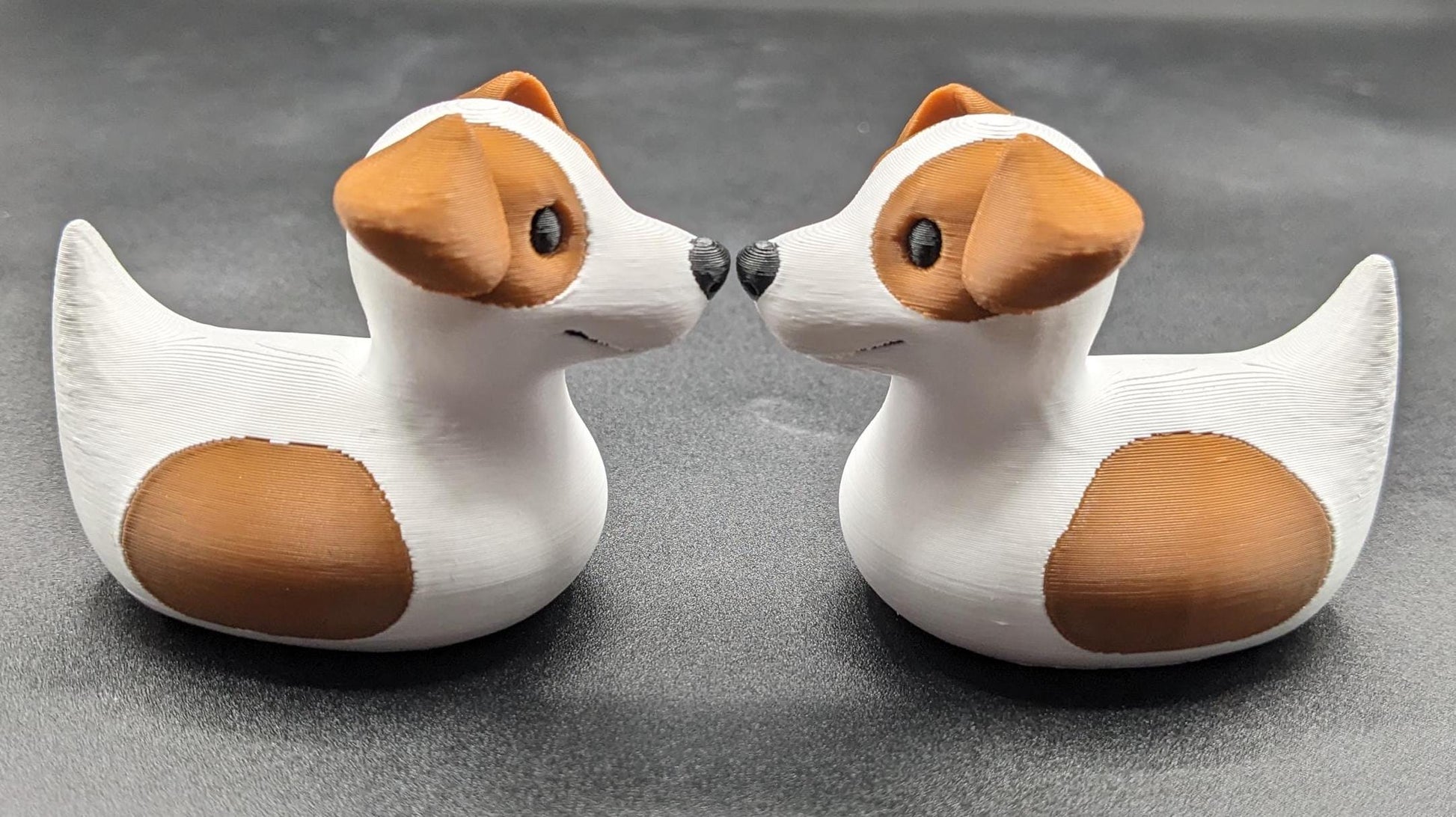 All our ducks are printed in PETG filament, a more expensive filament without the upcharge, as PETG is UV stable, heat and moisture tolerant. PLA color will fade if left on the dash of a car or in direct sunlight. Say hello to the Friendly Jack Russell Terrier Dog Duck Toy, the perfect blend of playful charm and quirky creativity! Whether you’re a dog lover, a Jeep duck collector, or simply someone who enjoys unique and fun decor, this adorable hybrid toy is sure to bring a smile to your face.