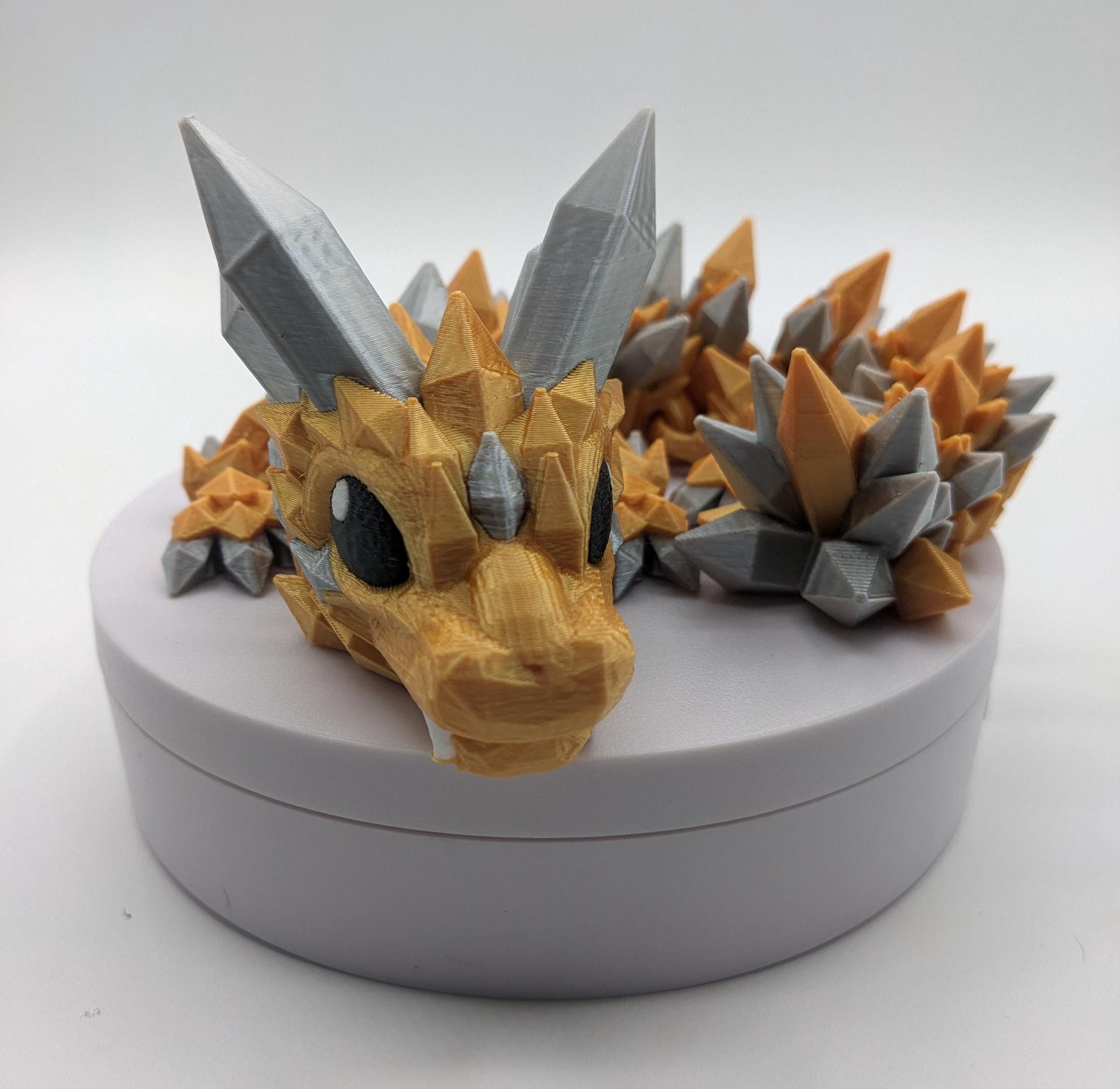 Bring a touch of magic to your life with the Adorable Articulated Baby Crystal Dragon! This 3D-printed masterpiece is designed with intricate details and fully articulated joints, making it a playful and poseable collectible that’s perfect for dragon lovers, fantasy fans, and unique gift seekers. Inspired by the elegance of crystals and the charm of baby dragons, this figurine is both whimsical and eye-catching.