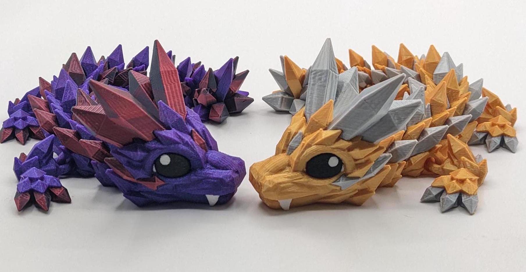 Bring a touch of magic to your life with the Adorable Articulated Baby Crystal Dragon! This 3D-printed masterpiece is designed with intricate details and fully articulated joints, making it a playful and poseable collectible that’s perfect for dragon lovers, fantasy fans, and unique gift seekers. Inspired by the elegance of crystals and the charm of baby dragons, this figurine is both whimsical and eye-catching.