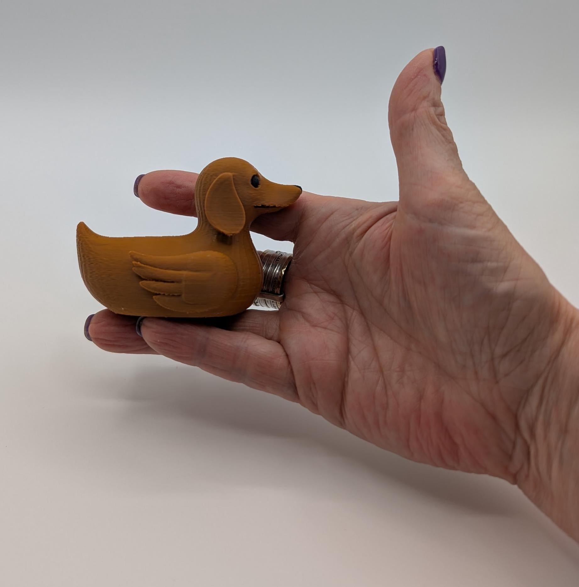 Say hello to the Adorable Dachshund Wiener Dog Duck, a quirky and lovable 3D-printed hybrid that combines the long-bodied charm of a dachshund with the playful personality of a duck. This whimsical design is perfect for dog lovers, dachshund enthusiasts, Jeep duck collectors, or anyone who enjoys unique and creative collectibles.