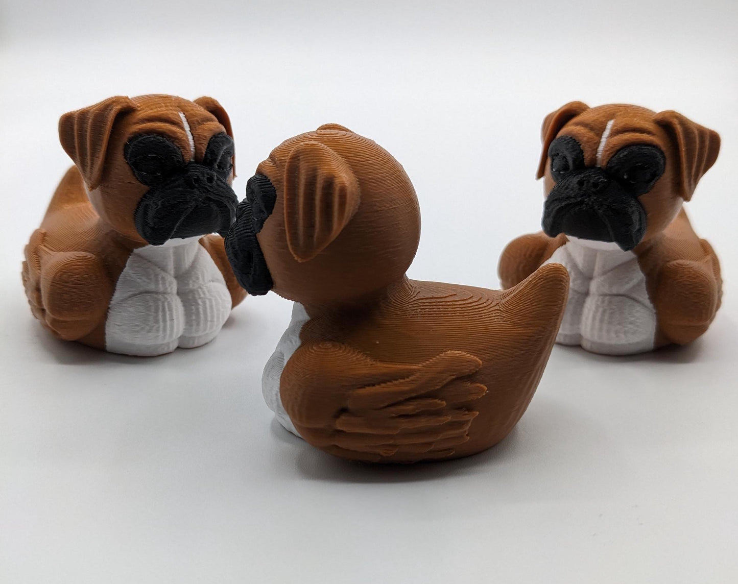 Meet The Magnificent Boxer Duck, a creative and charming 3D-printed hybrid that combines the strong, playful personality of a Boxer dog with the whimsical charm of a duck! This one-of-a-kind figurine is perfect for Boxer lovers, dog enthusiasts, Jeep duck collectors, or anyone who enjoys quirky and imaginative decor. Whether displayed on a shelf, a Jeep dash, added to your collection, or given as a thoughtful gift, this Boxer Duck is guaranteed to bring smiles and brighten up any room.