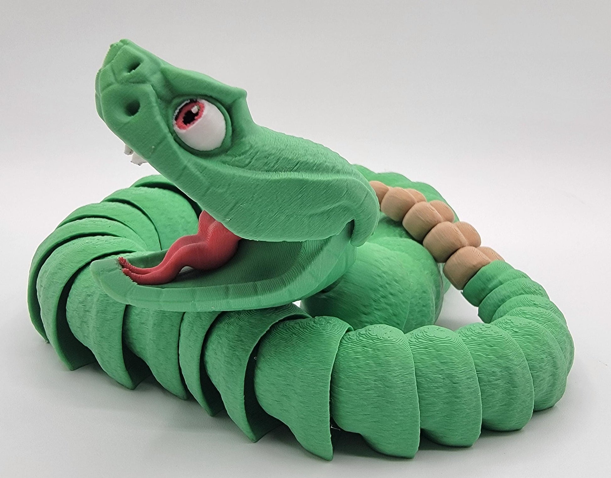 Unleash the charm of the wild with the Articulated Rattlesnake Fidget Toy, a unique 3D-printed creation that’s fun, flexible, and incredibly satisfying to play with! Designed with intricate details, this articulated rattlesnake moves and bends smoothly, providing endless entertainment and stress relief for kids, teens, and adults. Whether you're a fidget toy enthusiast, a snake lover, or just looking for a creative gift, this rattlesnake is guaranteed to be a hit.