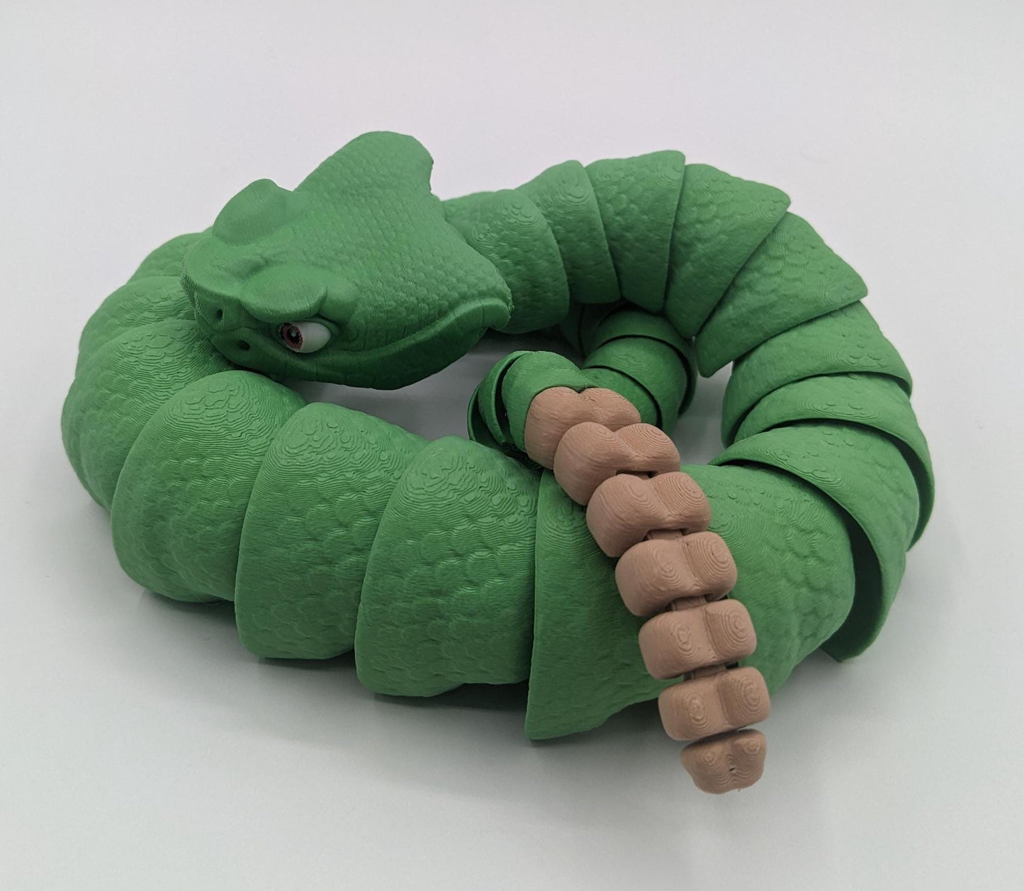 Unleash the charm of the wild with the Articulated Rattlesnake Fidget Toy, a unique 3D-printed creation that’s fun, flexible, and incredibly satisfying to play with! Designed with intricate details, this articulated rattlesnake moves and bends smoothly, providing endless entertainment and stress relief for kids, teens, and adults. Whether you're a fidget toy enthusiast, a snake lover, or just looking for a creative gift, this rattlesnake is guaranteed to be a hit.