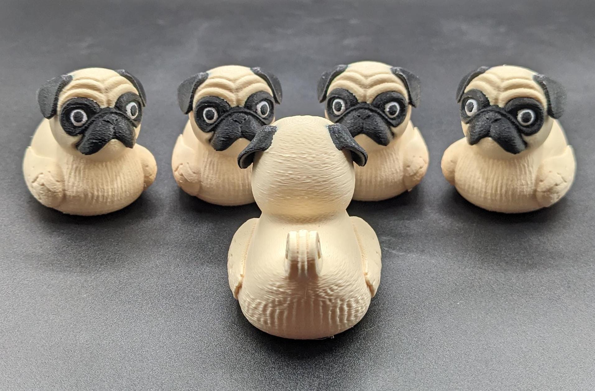 Meet The Fabulous Pug Dog Duck, a delightful 3D-printed creation that combines the charm of a pug with the whimsy of a rubber duck! This quirky and adorable design is perfect for pug lovers, Jeep duck collectors, duck enthusiasts, or anyone who enjoys playful and unique decor. Whether it’s displayed on a shelf, on the dash of your car, used as a conversation starter, or gifted to a dog or Jeep lover, this pug duck is guaranteed to bring smiles and laughter.