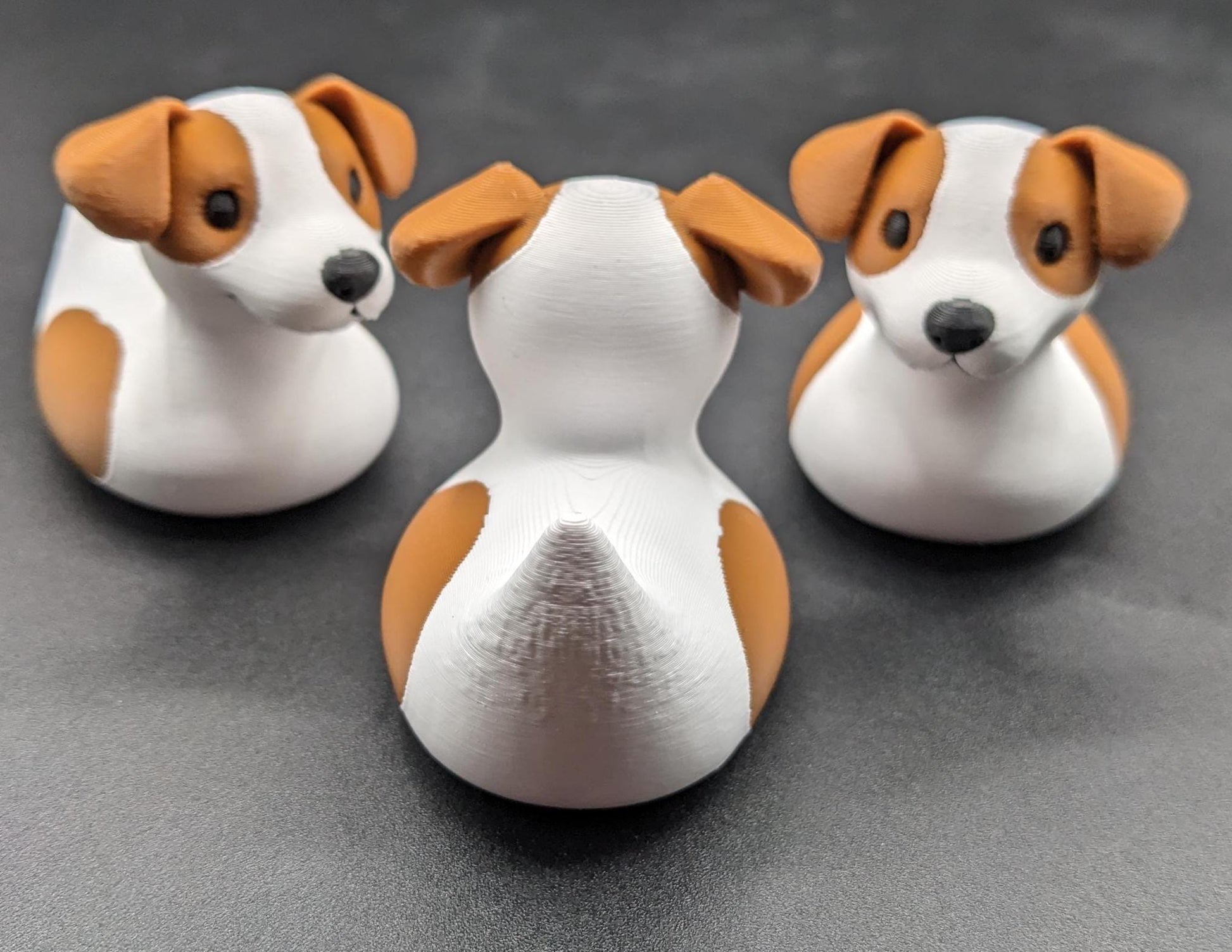 All our ducks are printed in PETG filament, a more expensive filament without the upcharge, as PETG is UV stable, heat and moisture tolerant. PLA color will fade if left on the dash of a car or in direct sunlight. Say hello to the Friendly Jack Russell Terrier Dog Duck Toy, the perfect blend of playful charm and quirky creativity! Whether you’re a dog lover, a Jeep duck collector, or simply someone who enjoys unique and fun decor, this adorable hybrid toy is sure to bring a smile to your face.