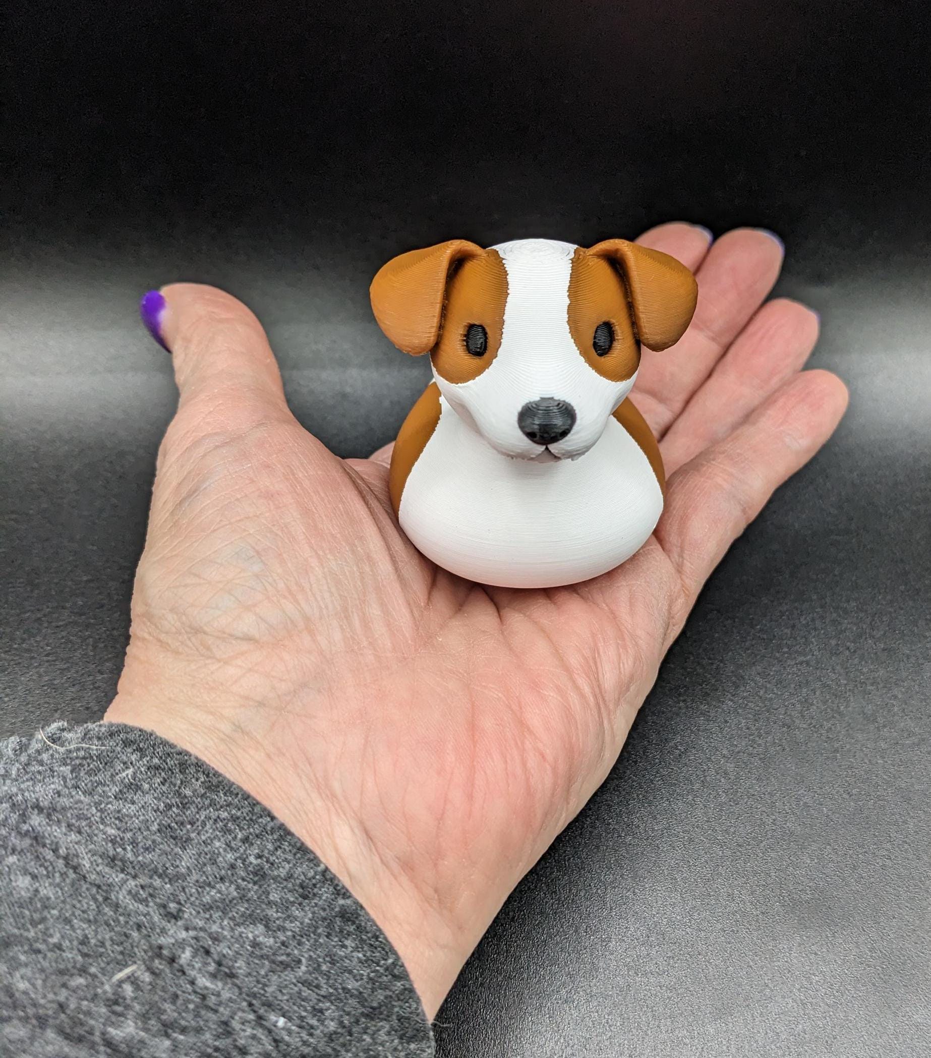 All our ducks are printed in PETG filament, a more expensive filament without the upcharge, as PETG is UV stable, heat and moisture tolerant. PLA color will fade if left on the dash of a car or in direct sunlight. Say hello to the Friendly Jack Russell Terrier Dog Duck Toy, the perfect blend of playful charm and quirky creativity! Whether you’re a dog lover, a Jeep duck collector, or simply someone who enjoys unique and fun decor, this adorable hybrid toy is sure to bring a smile to your face.