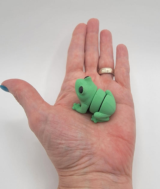Meet our adorable 3D printed  Tiny Sensory Articulated Fidget Frog– your pocket-sized companion for stress relief and endless fun! Crafted with precision, this tiny articulated frog is more than just a toy; it's a delightful escape from the daily hustle. Feel the smooth texture and enjoy the satisfying tactile experience whenever you need a moment of calm.